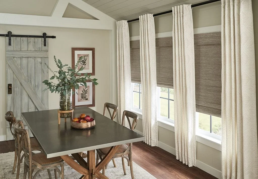 Floor-to-ceiling drapery panels add height and interest to this wall of dining room windows