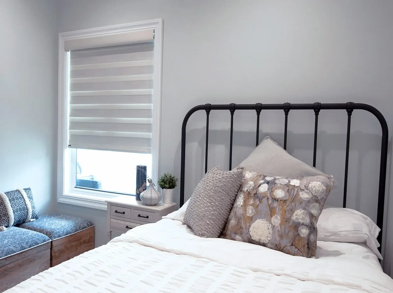 Sheer shades partially lowered in a bedroom