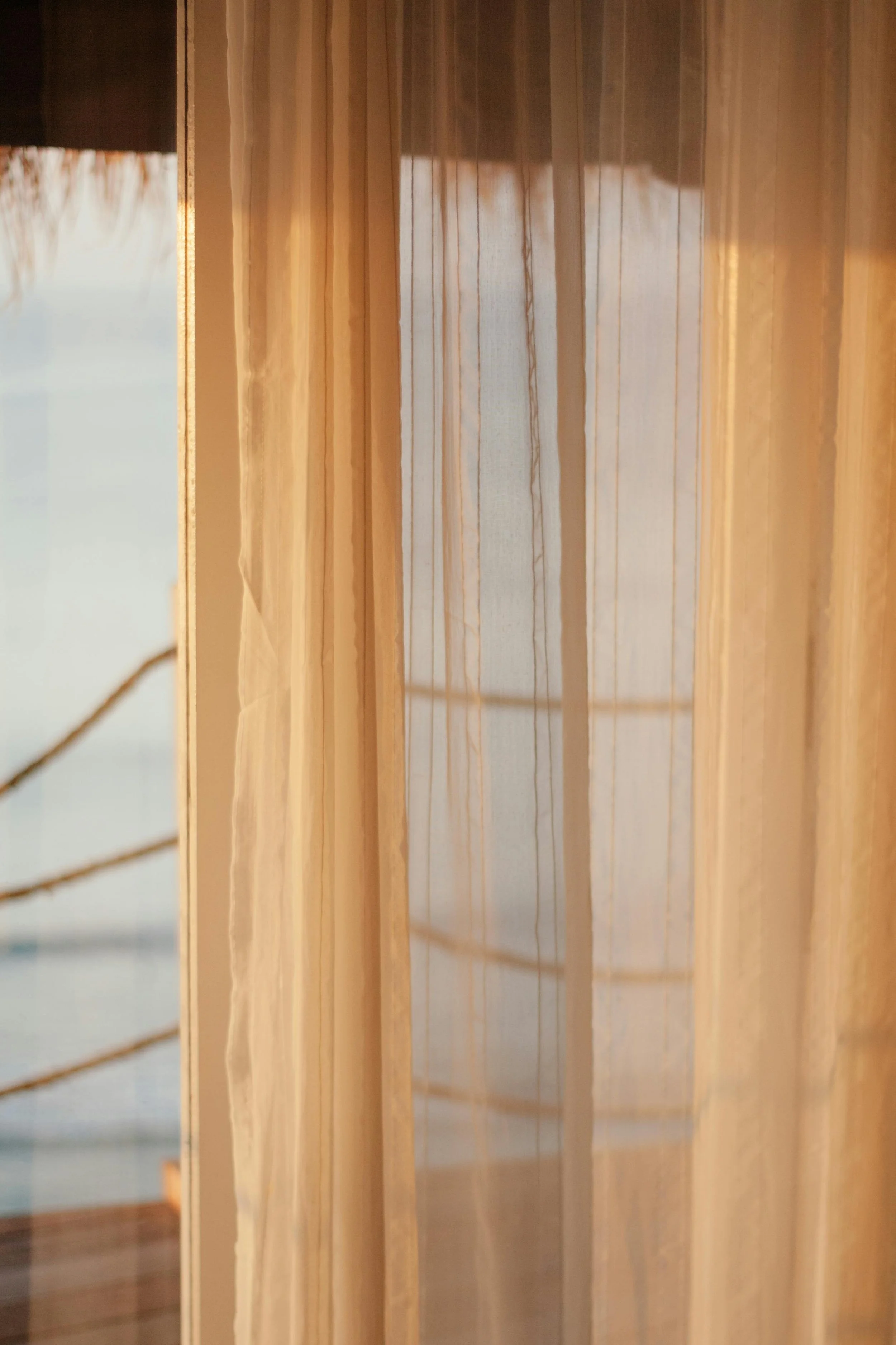 Soft sunlight filtering through wooden blinds, creating a warm and intimate atmosphere.
