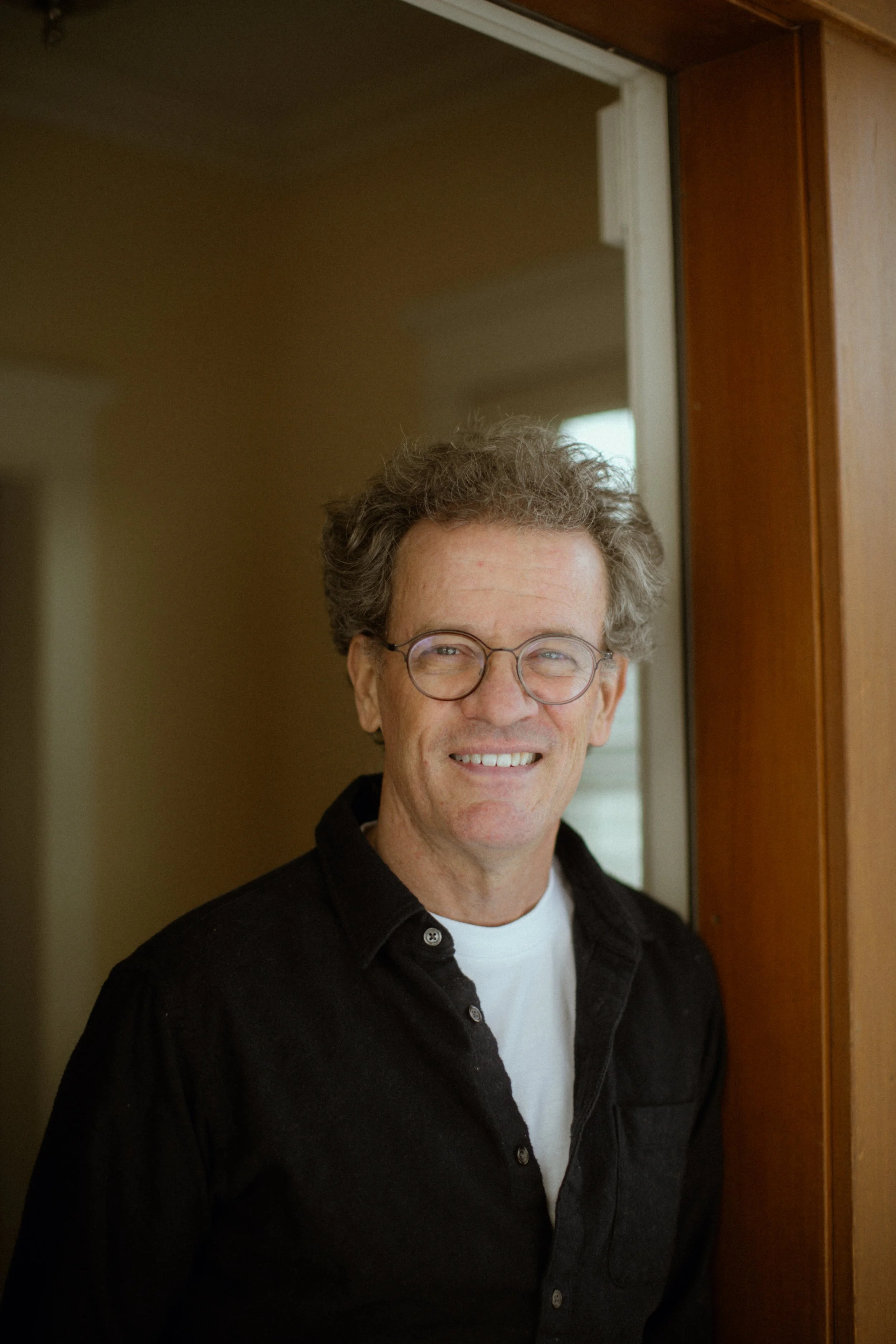 Yann Martel standing by door entrance, smiling