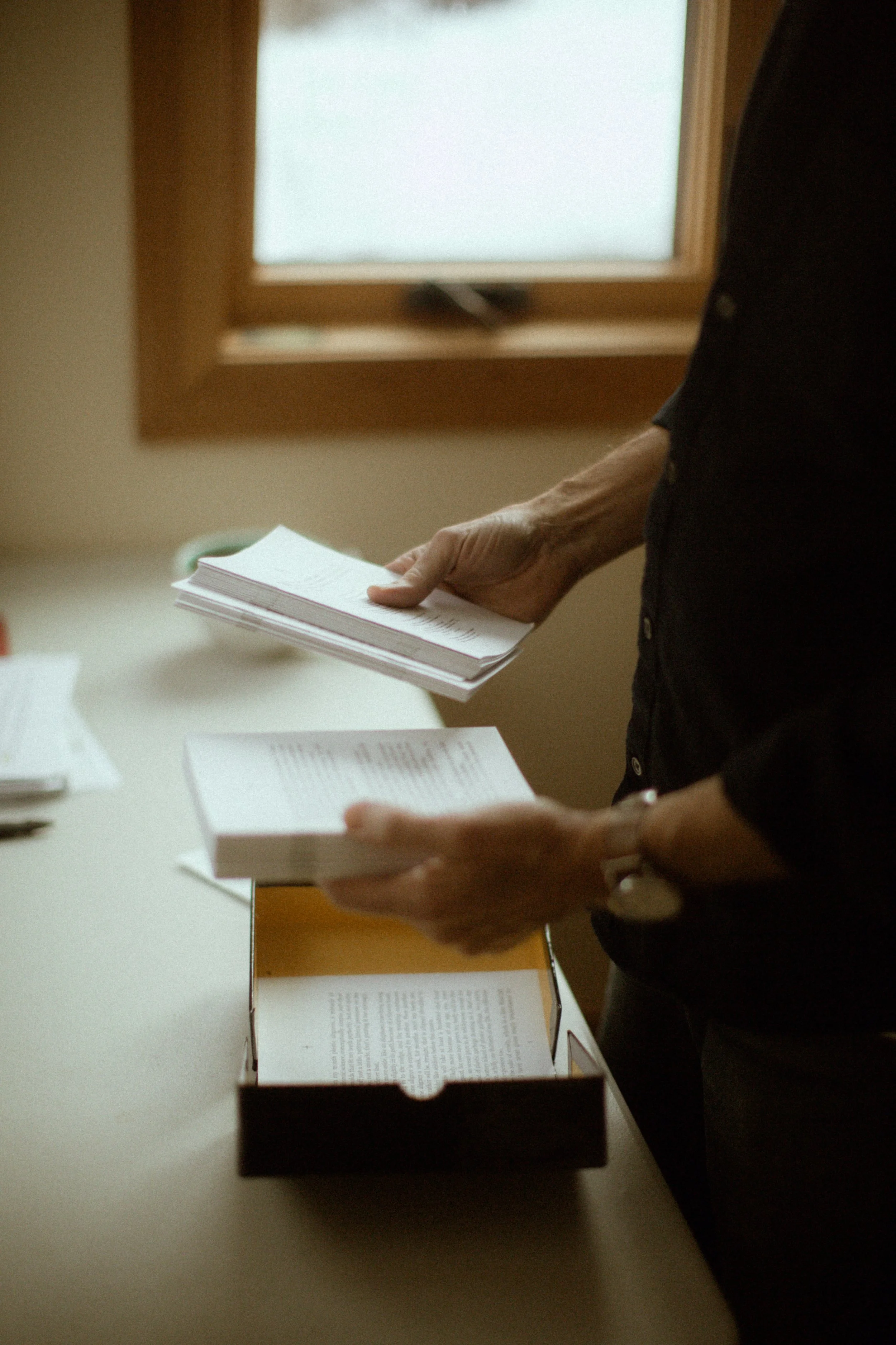 Yann Martel sorting through a box of small books