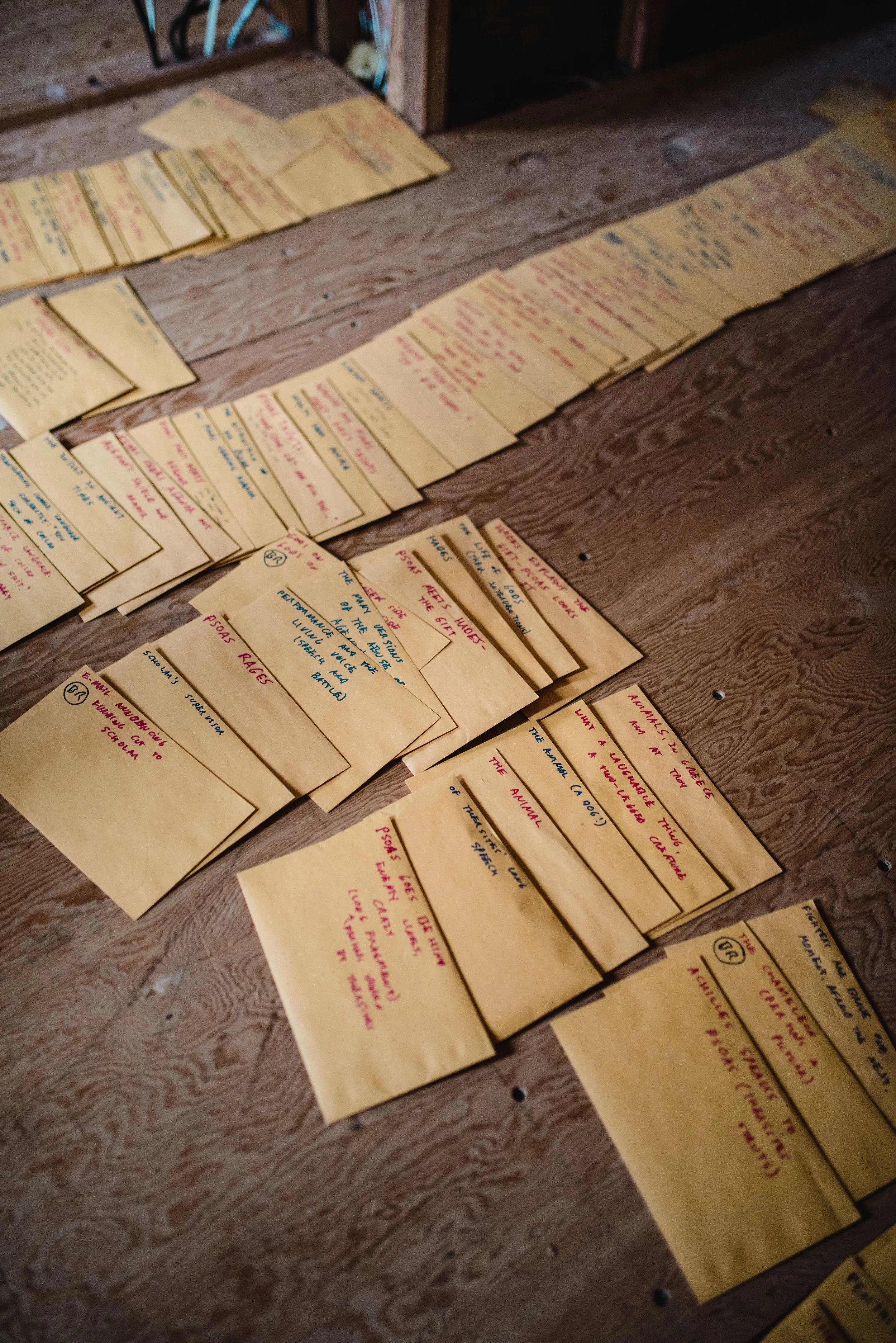Envelopes arranged in rows on a wooden floor