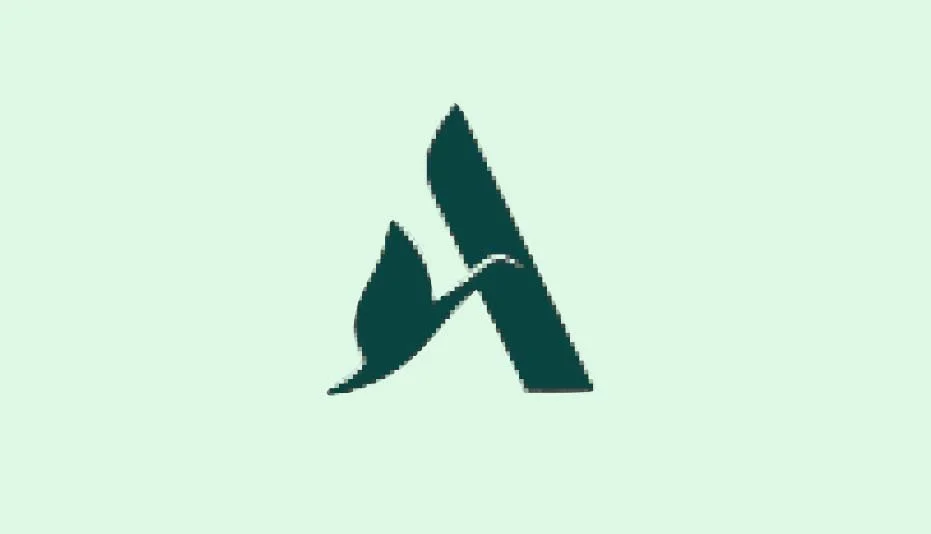 Silhouette of a bird flying near a large stylized letter 'A'