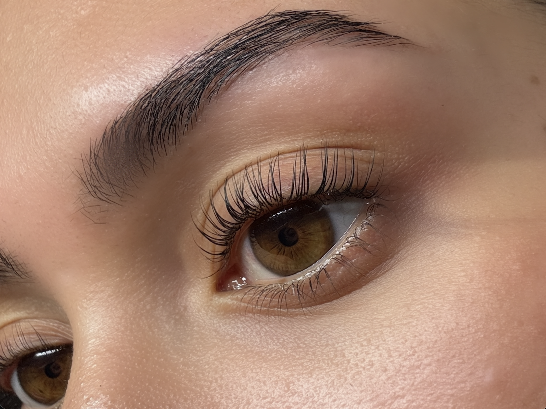 Before-and-after style close-up highlighting lash lift, lash tint, brow lamination and HD brows by Sakoura Aesthetics in South London.