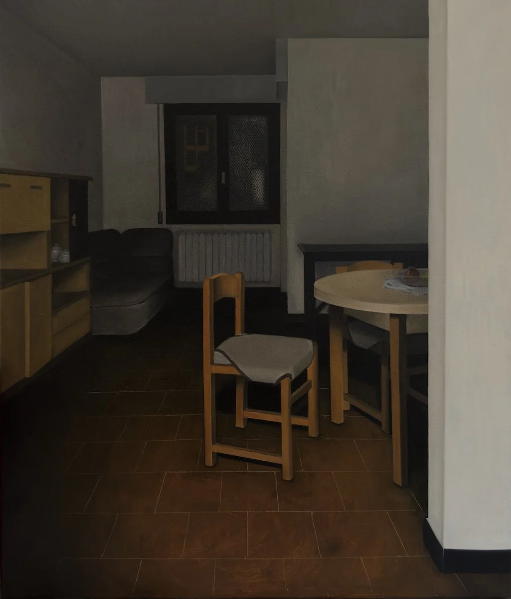 An empty dining room, dimly lit and suspended in silence. At the center, a solitary chair disrupts the stillness without claiming it. The space feels paused rather than abandoned—familiar yet inaccessible, as if memory has slightly misaligned with re