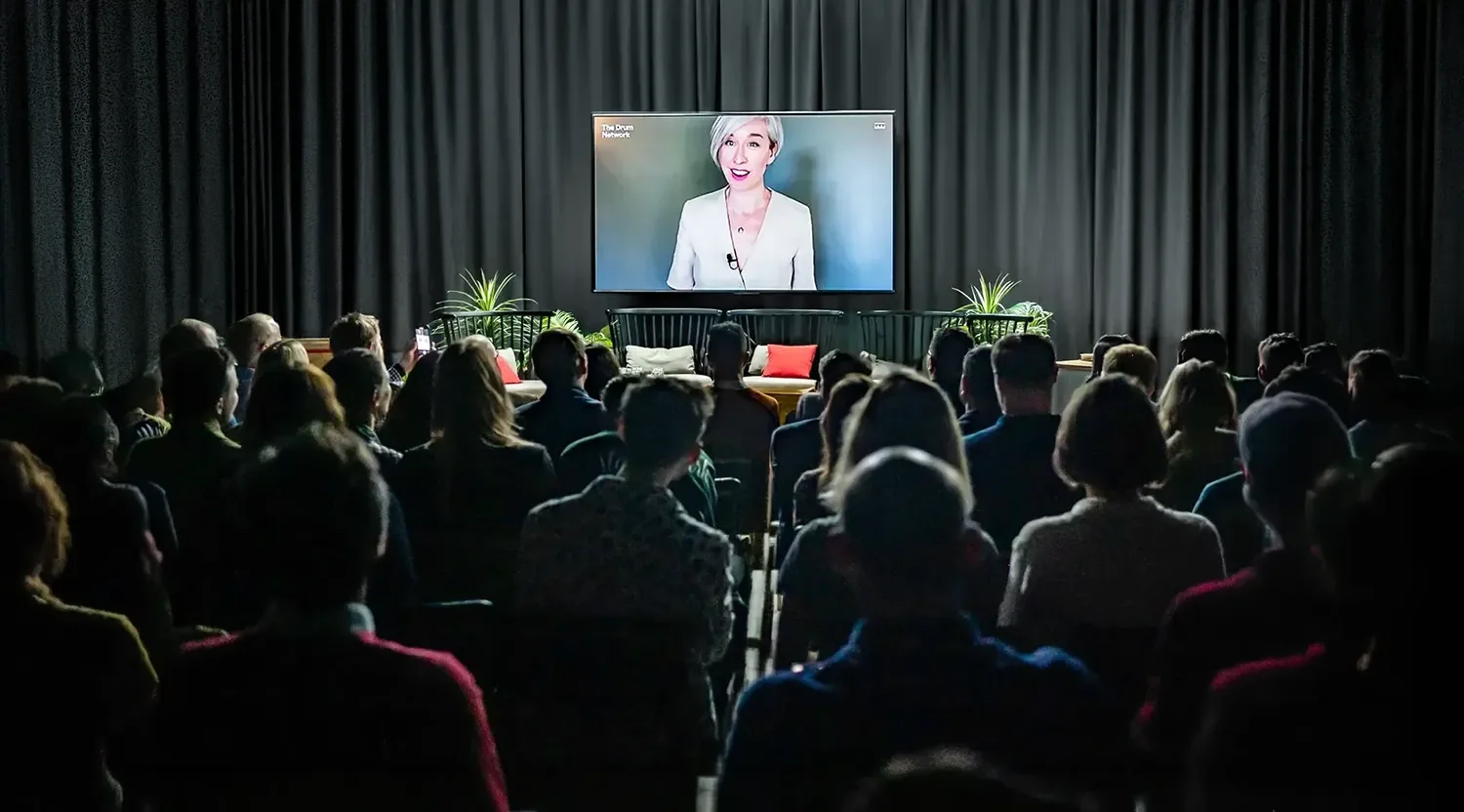Niki McMorrough presenting on screen to an audience, acting as a fractional marketing director mentoring internal teams