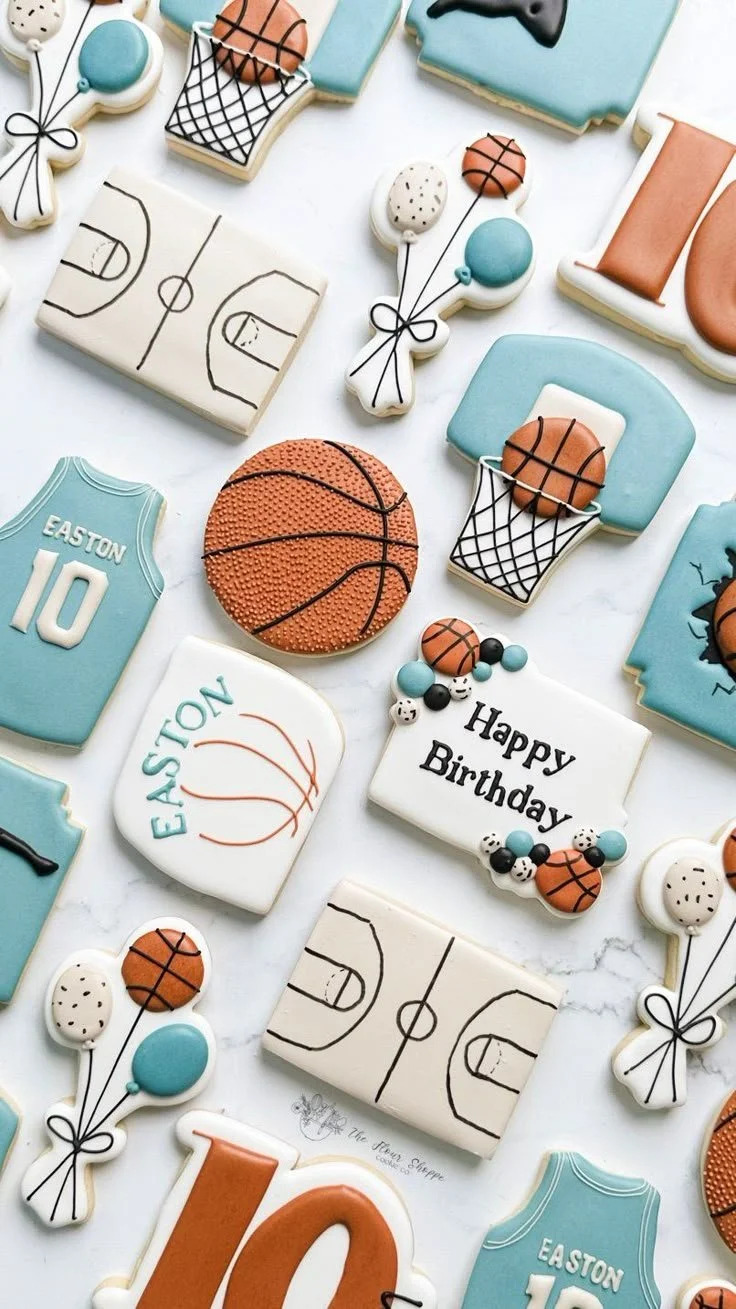 Decorative cookies for a birthday with basketball and sports themes, including basketball-shaped cookies, basketball hoop cookies, and sports jersey cookies, along with a "Happy Birthday" message.