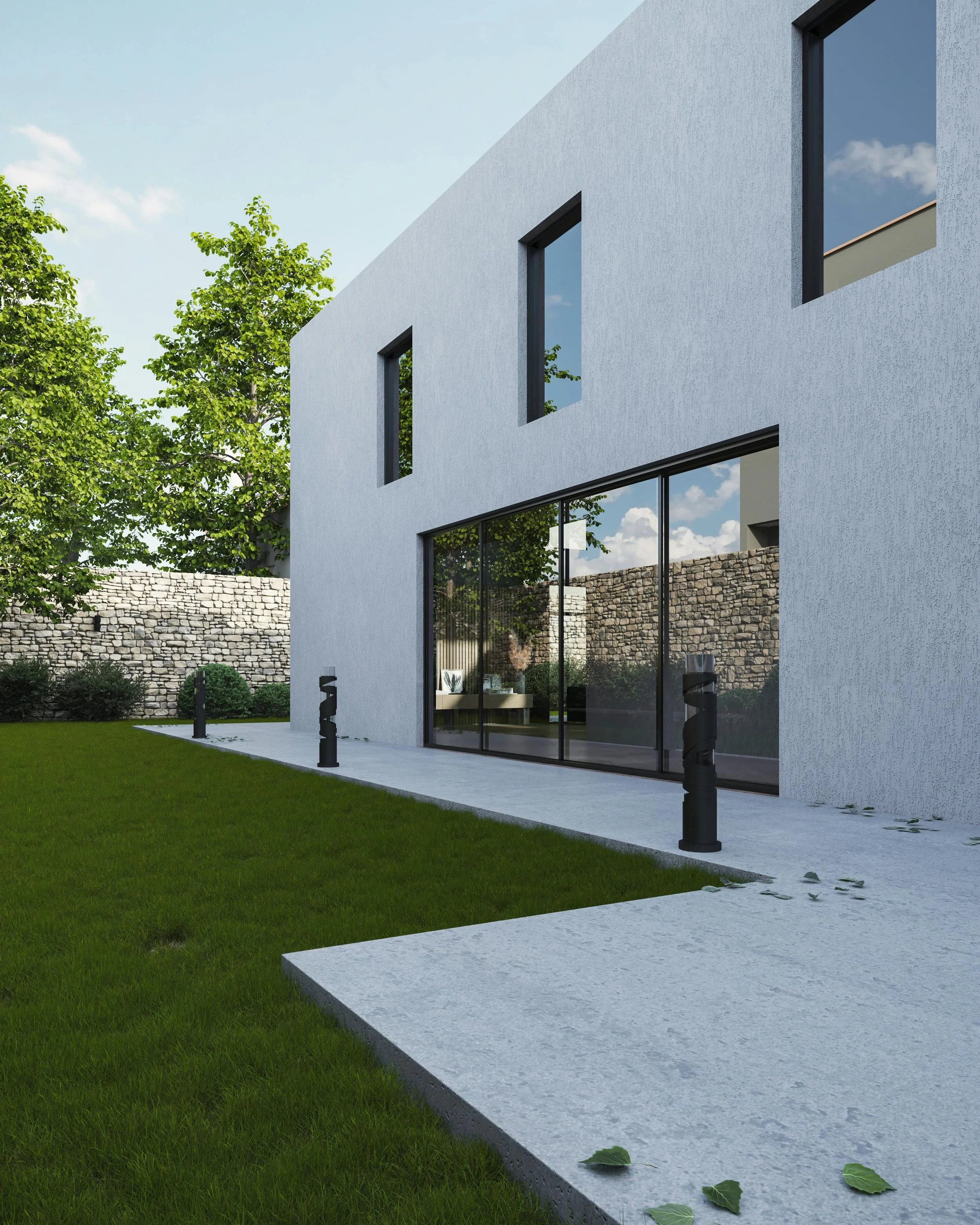 Modern white building with large glass windows, surrounded by green grass and trees, under a blue sky with some clouds.