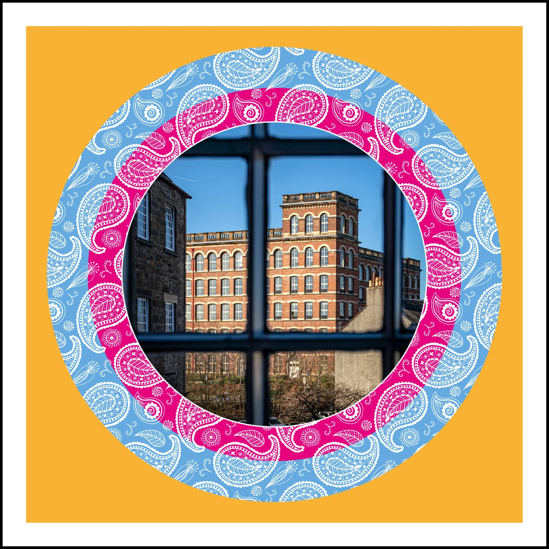 Photo of a historic red-brick building viewed through a window with black bars, framed by a colorful decorative border with paisley patterns on a yellow background.