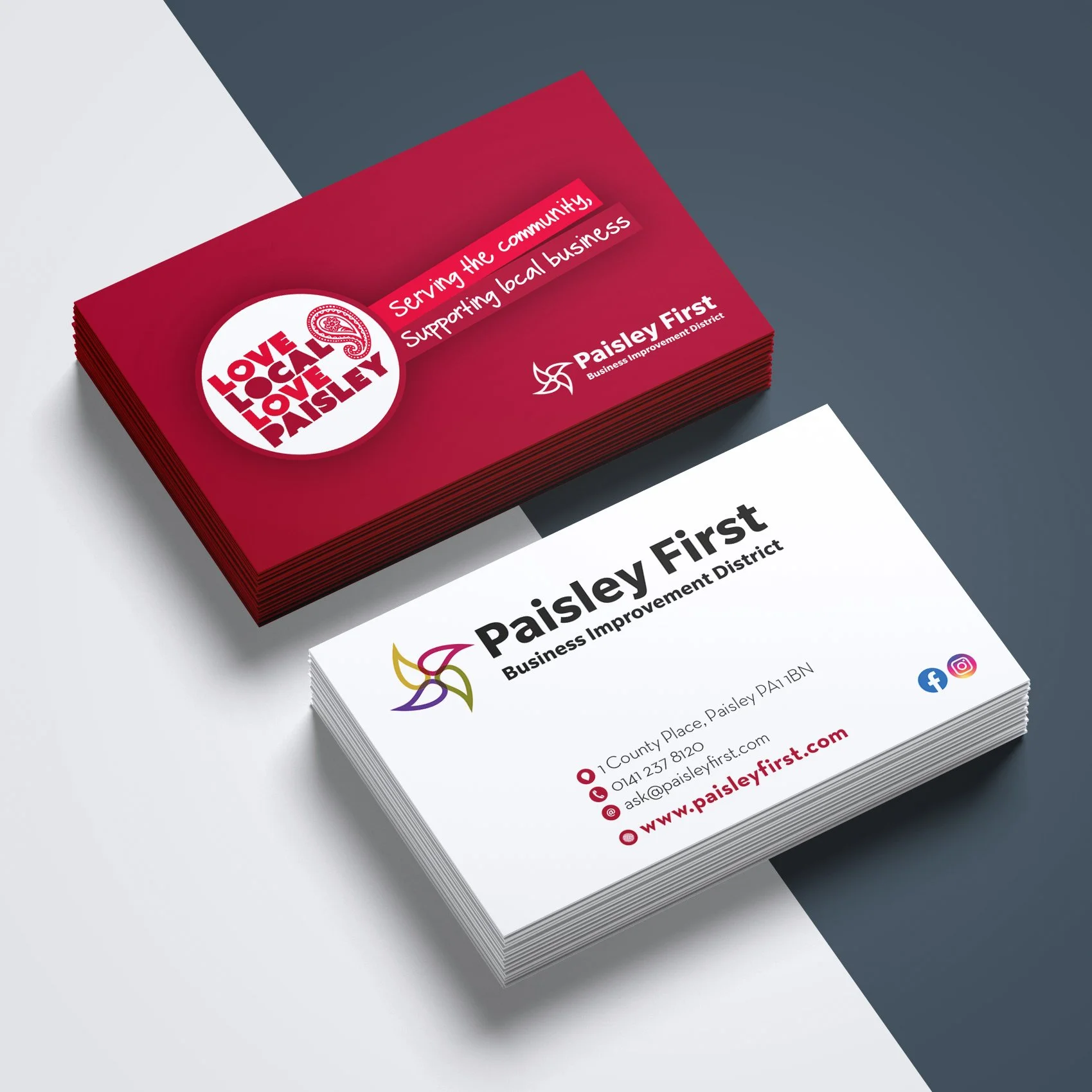 Business cards stacked, one red with love local love Paisley logo, supporting local business slogan, and one white with Paisley First logo, contact info, website, and social media icons.