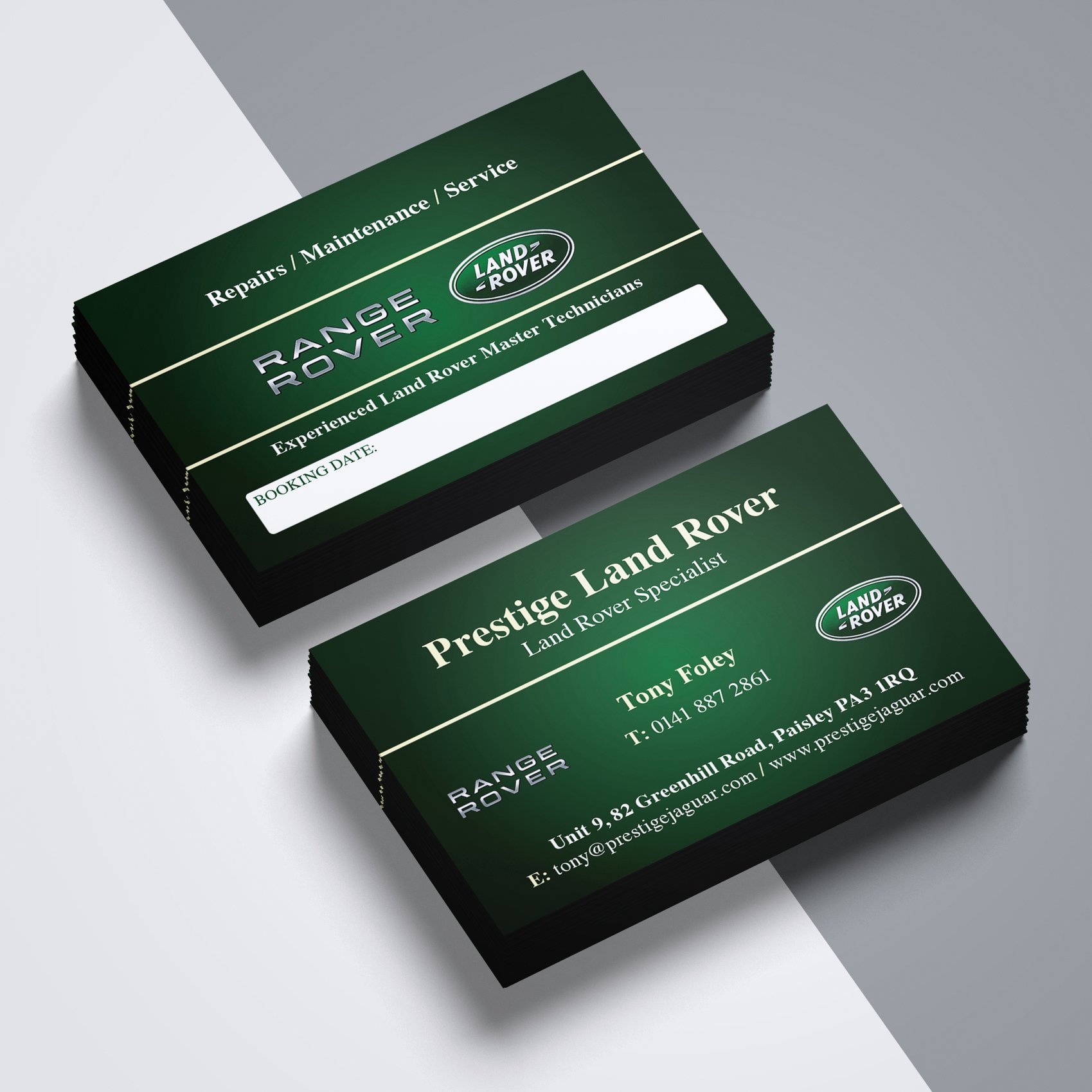 Stack of green business cards for Land Rover services, one showing contact information and the other for repairs and maintenance.