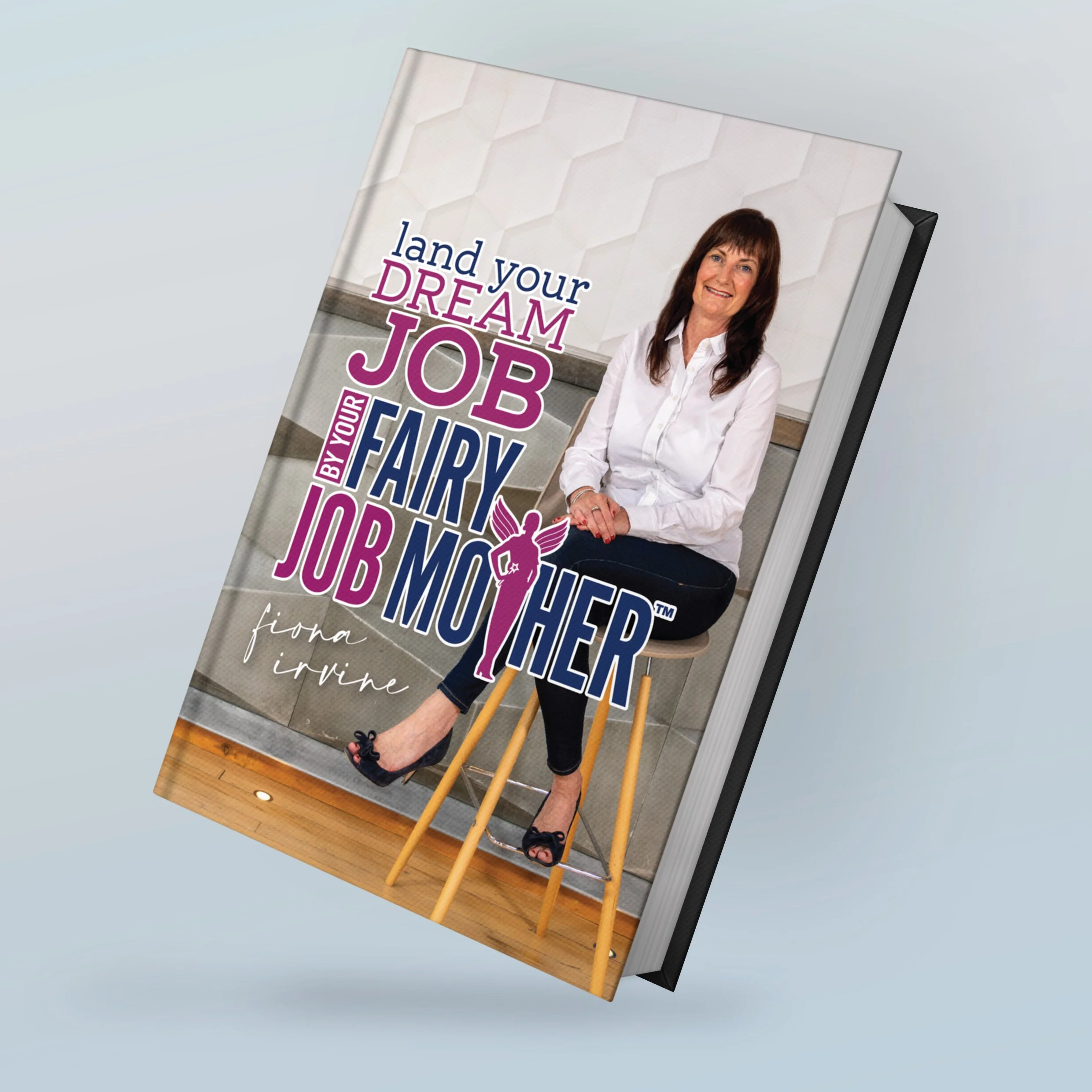 A book cover featuring a woman sitting on a stool, smiling, wearing a white shirt and black pants, with the title "Land your dream job by your fairy job mother" and the author name "Fiona Irvine."