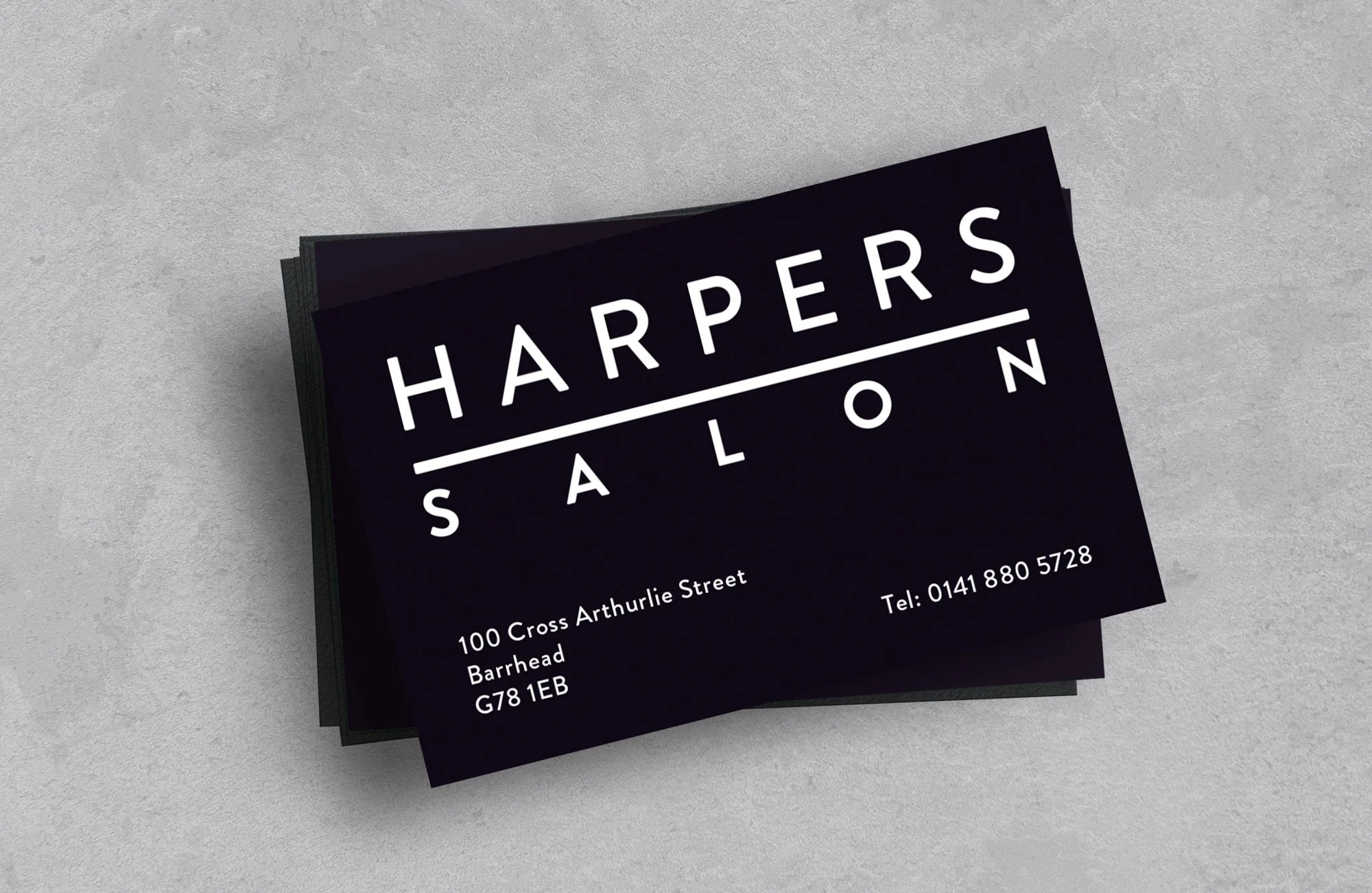 Business cards for Harper's Salon with black background, white text, the salon's name, address, and phone number.