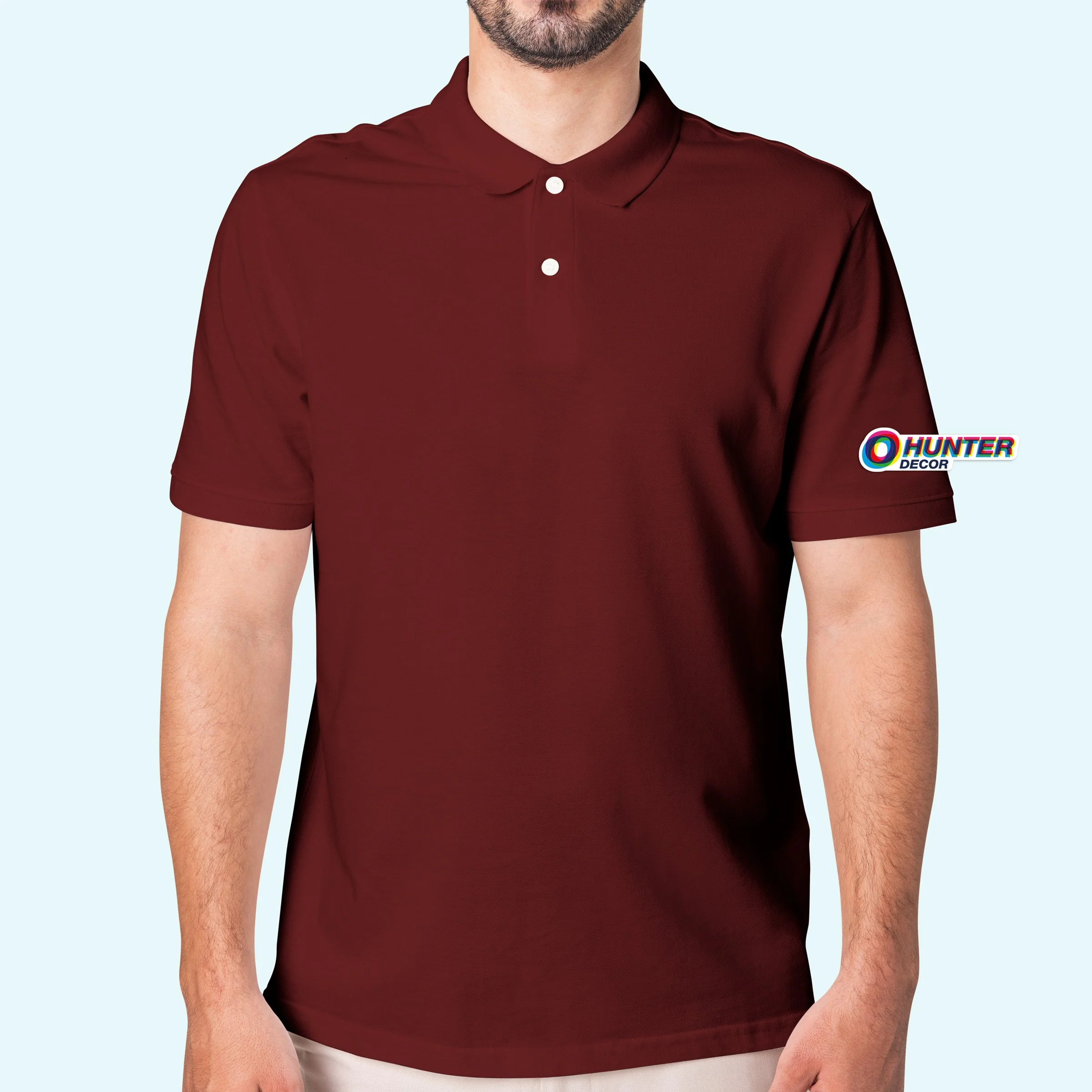 A man wearing a maroon polo shirt with white buttons, standing against a light blue background, with a small logo on the left sleeve that says Hunter Decor.