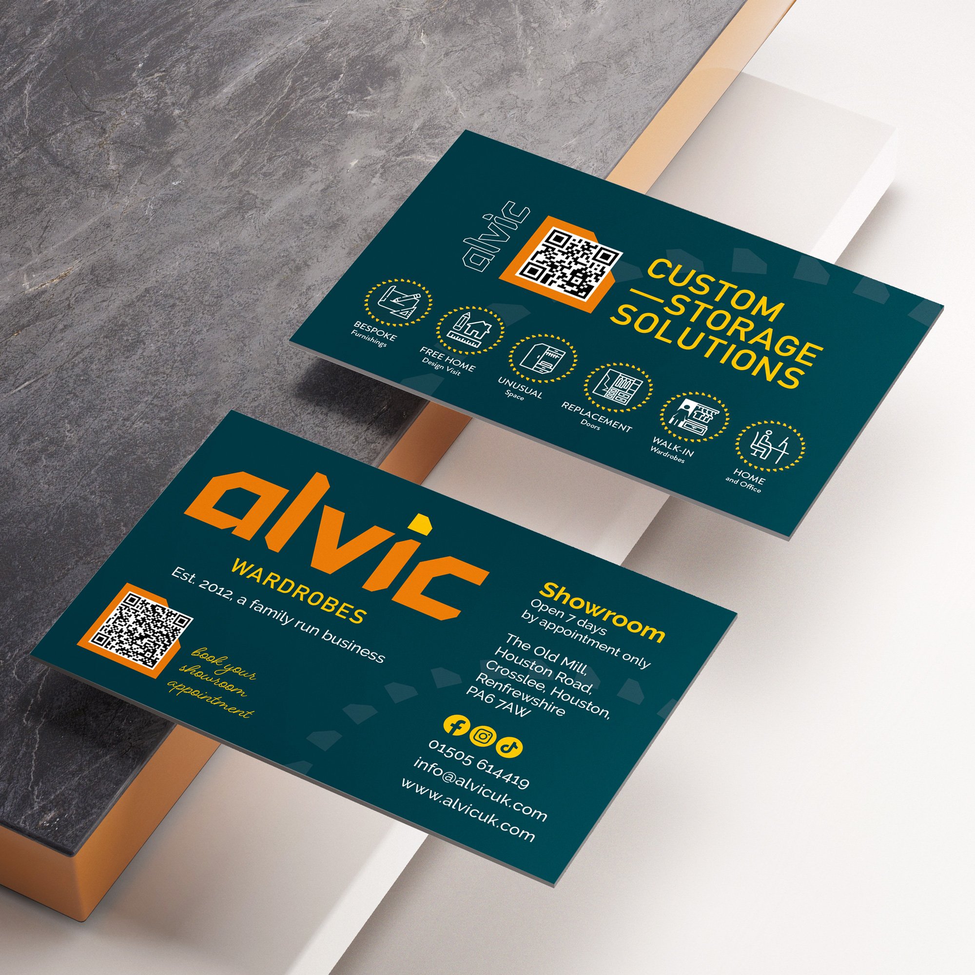 Business cards for Alvin Wardrobes, featuring contact information, a QR code, and icons indicating custom storage solutions, showroom location, and business details.