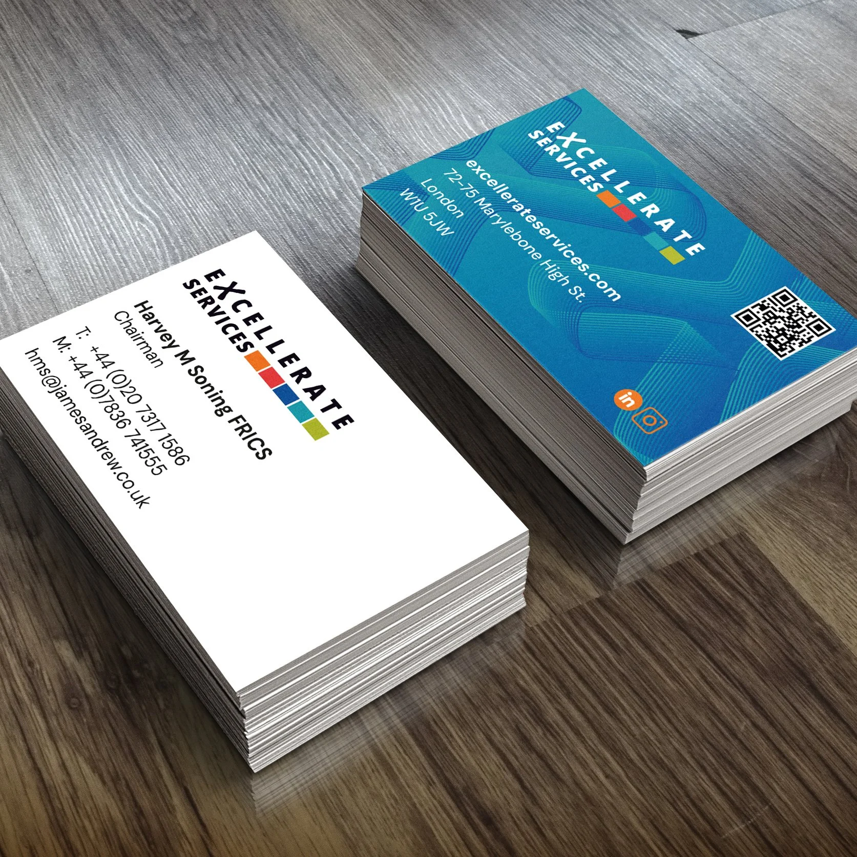 Business cards for Excelerate Services, with one card showing the front design in blue with contact information, and the other card displaying the back details in white with the company's name and contact info.