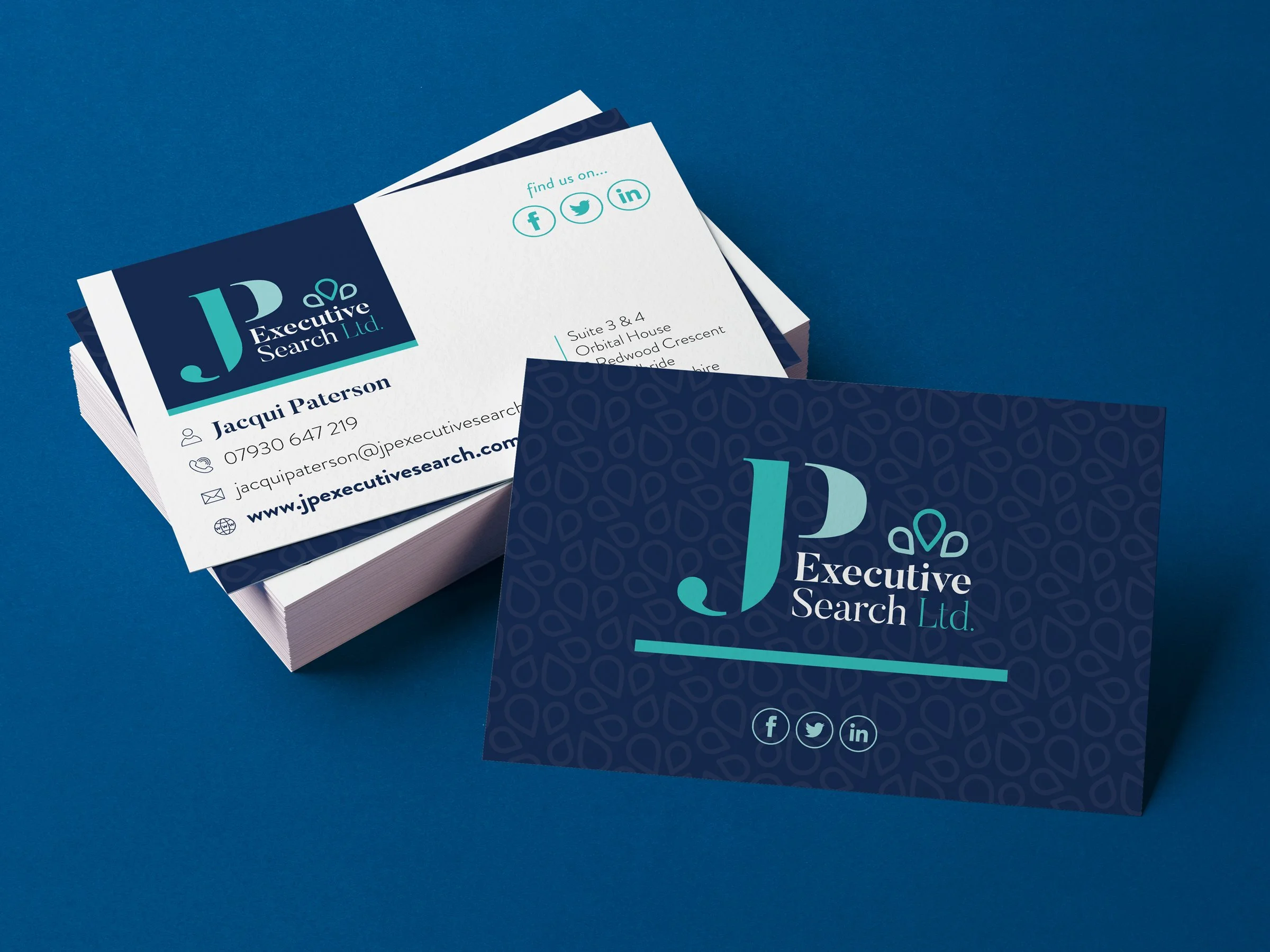 Stacks of business cards for Executive Search Ltd featuring a blue background, logo, and contact information.