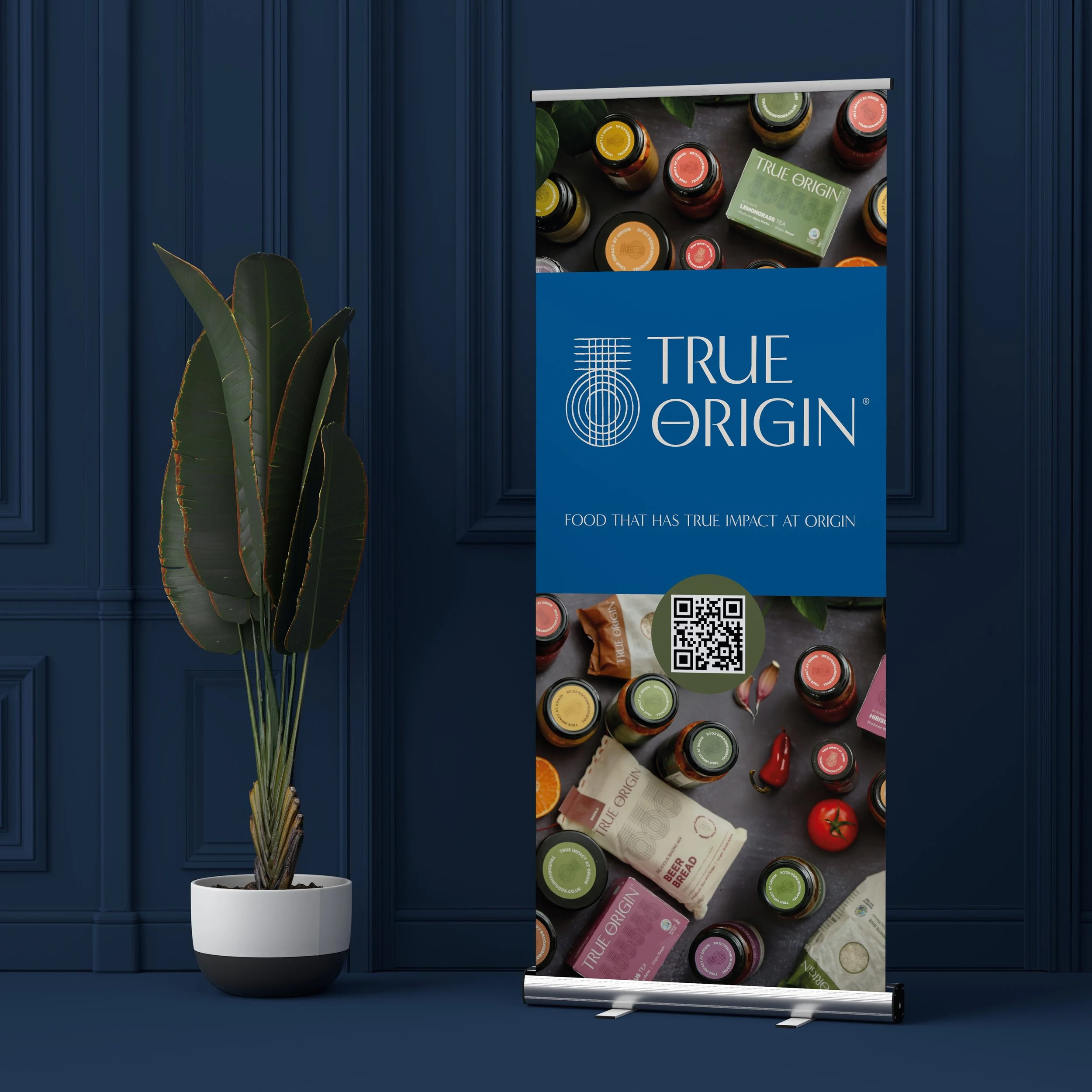 A vertical True Origin promotional banner with images of bottled products, packaging, and a QR code, set against a blue wall with a plant in a white pot.