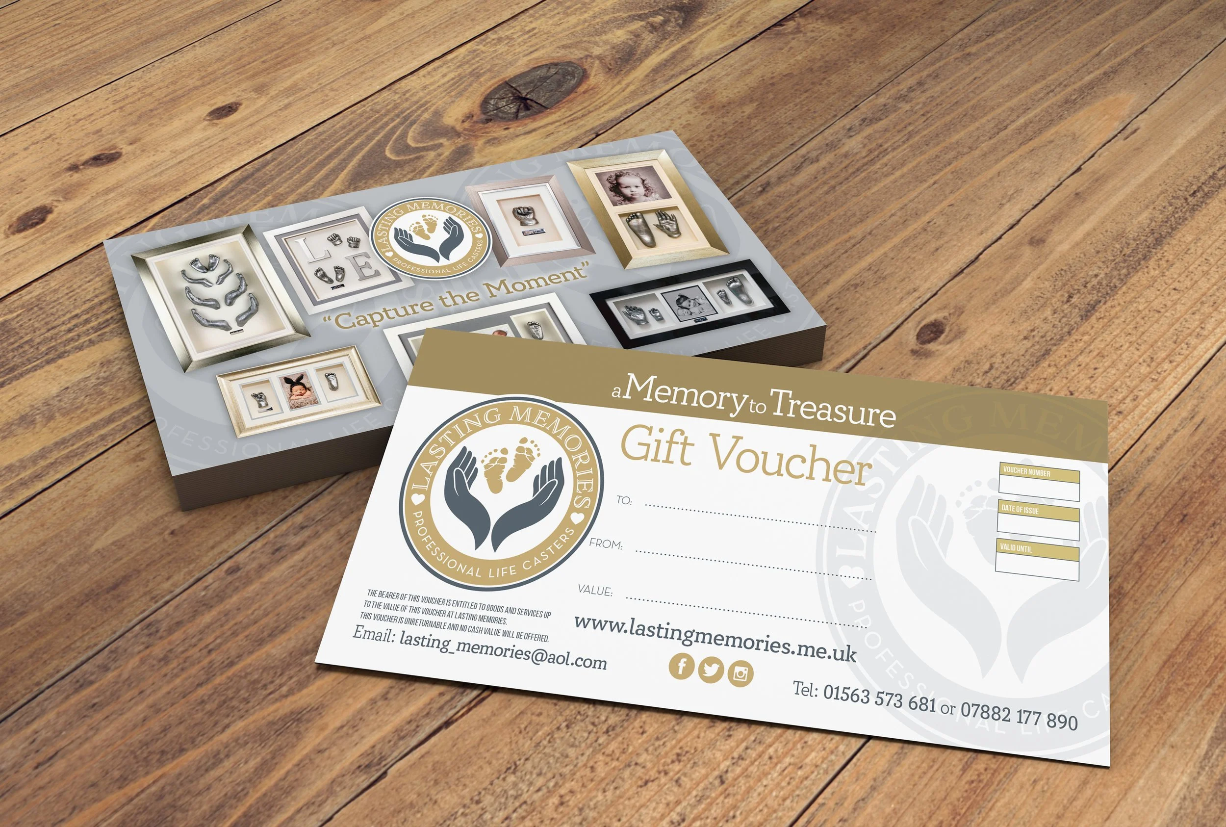 A gift voucher for Lasting Memories, featuring a logo with hands and footprints, and various images of personalized keepsakes. The voucher is placed on a wooden surface.