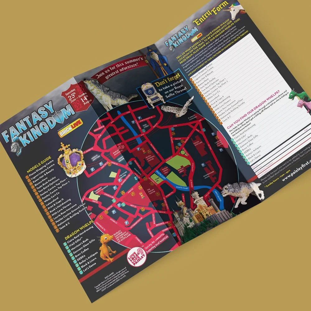 A colorful map of Fantasy Kingdom amusement park with toy dragons and crown souvenirs.