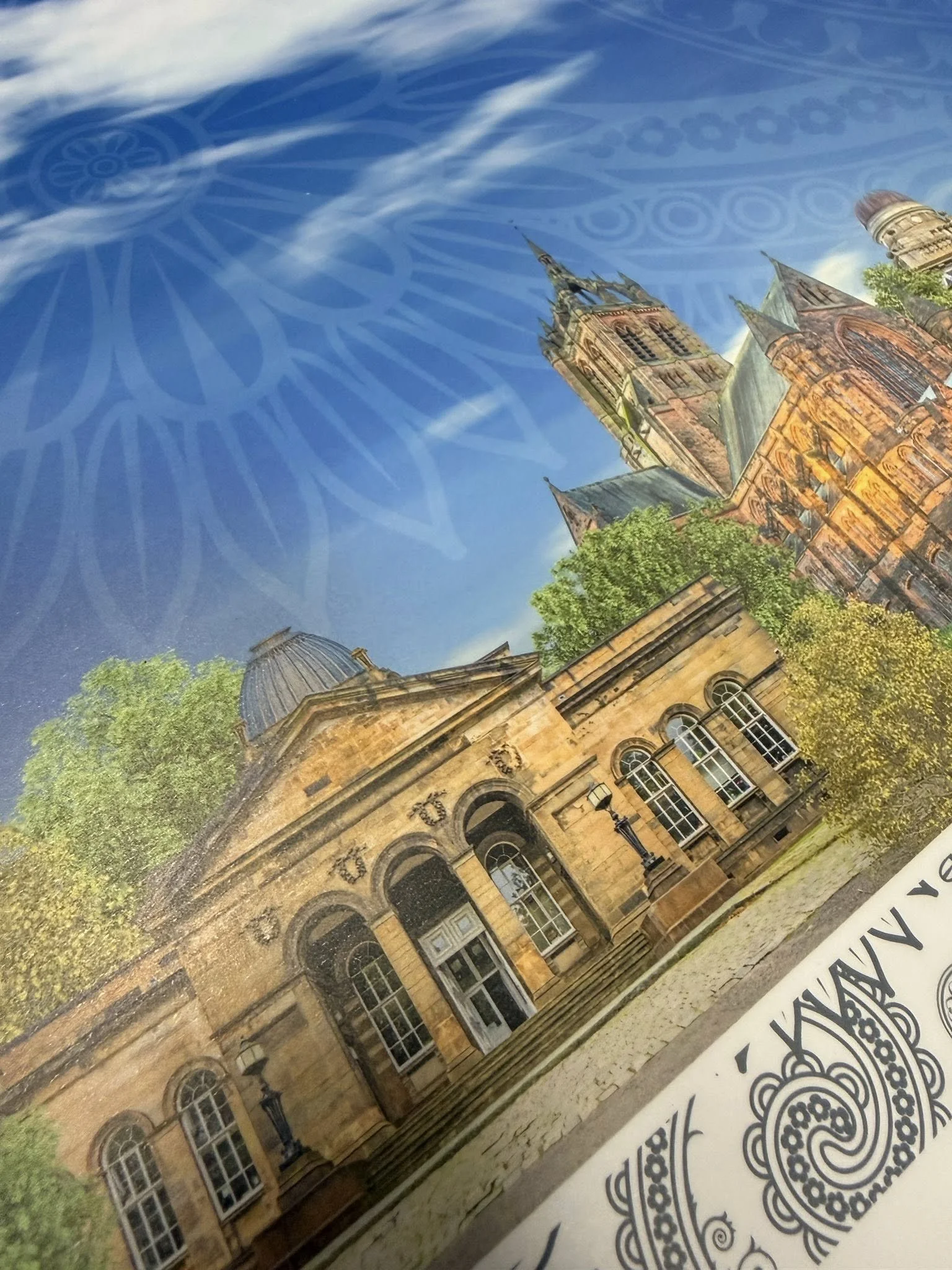 Photograph of a historic church with intricate architectural details, set amidst green trees, under a blue sky, with a decorative star pattern overlay.