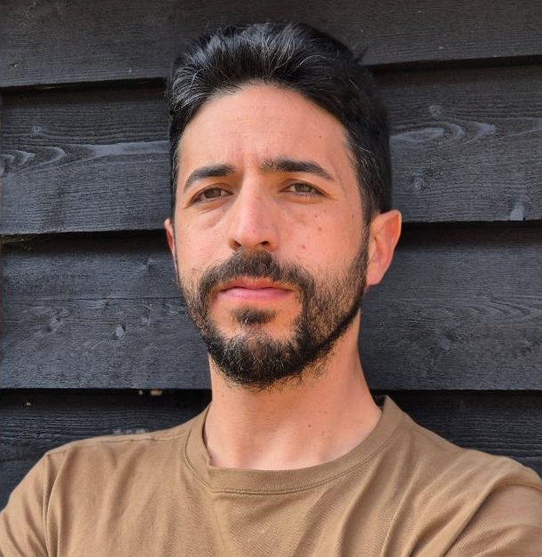 Man image, black hair, serious expression.