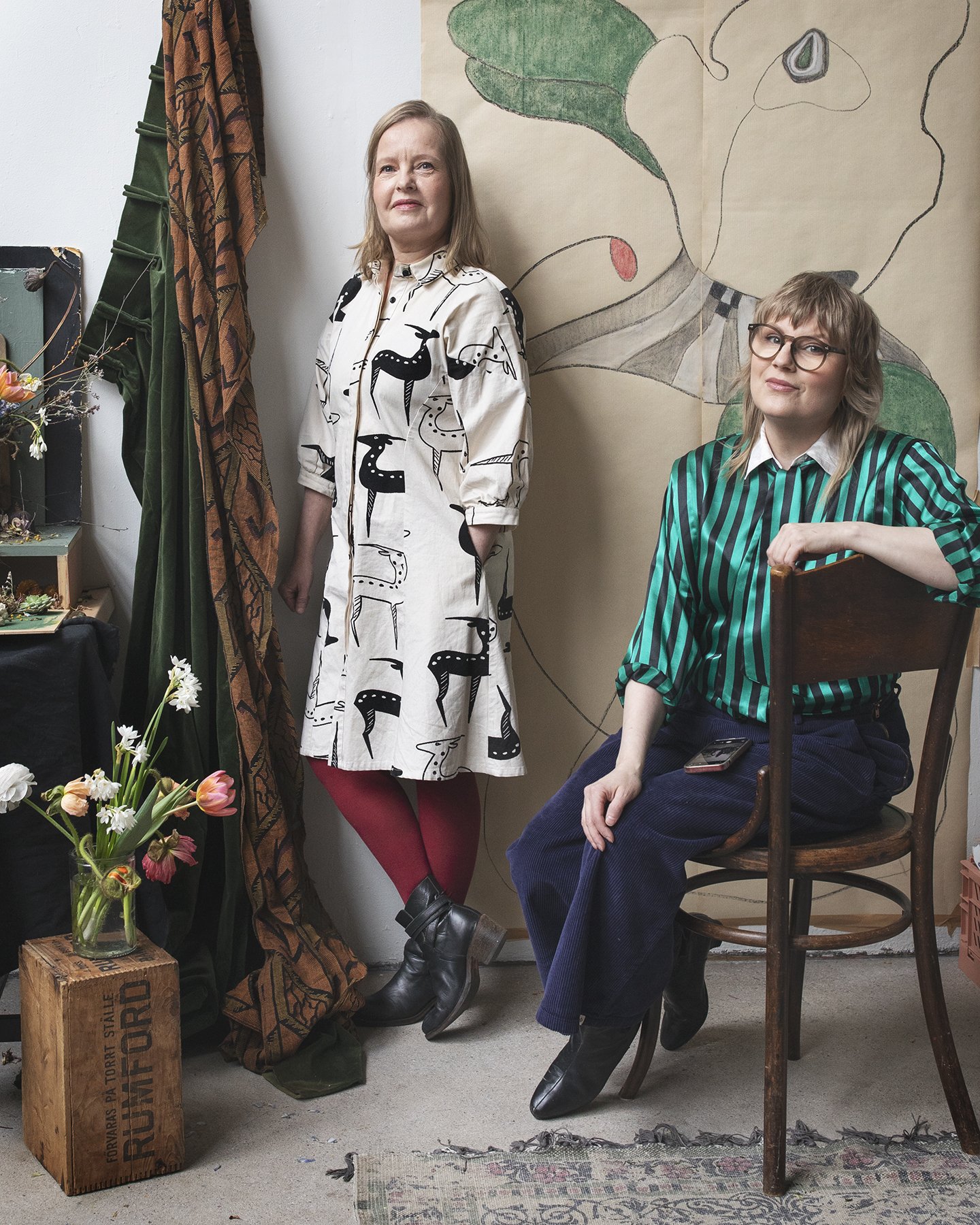 Kreetta Järvenpää and Anna Varakas, founders of Floral Fan magazine in an art studio with floral arrangements and artwork.