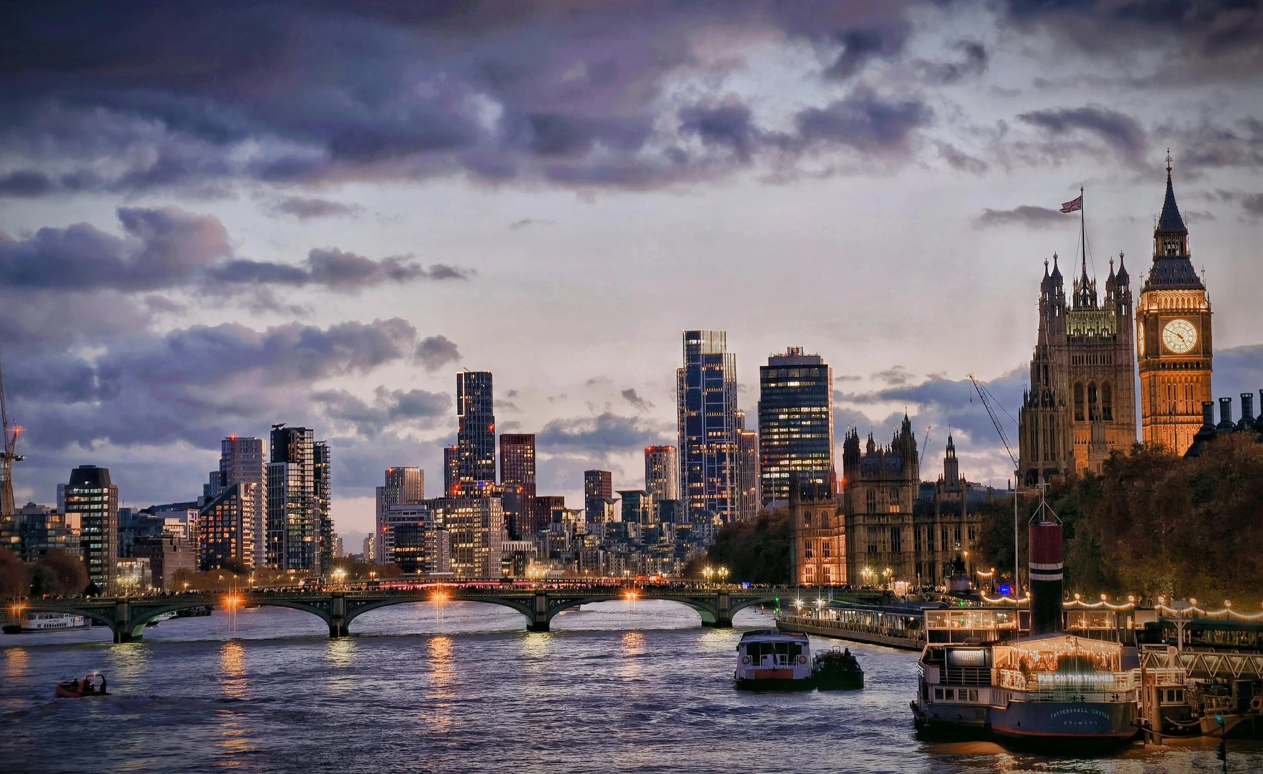 London skyline with Big Ben and River Thames at dusk, representing international travel and tour services