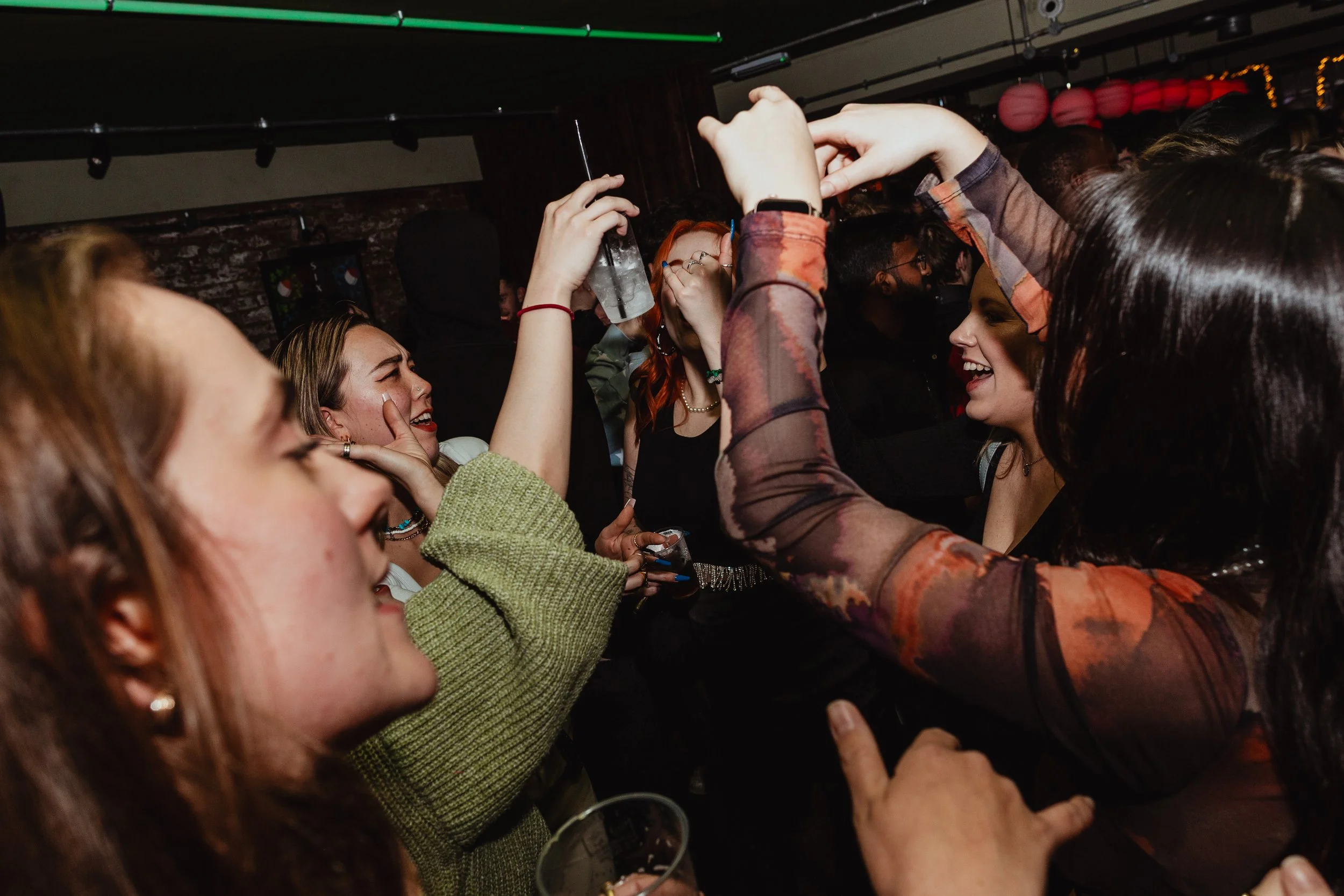 A group of young women having fun and dancing at a party or nightclub.