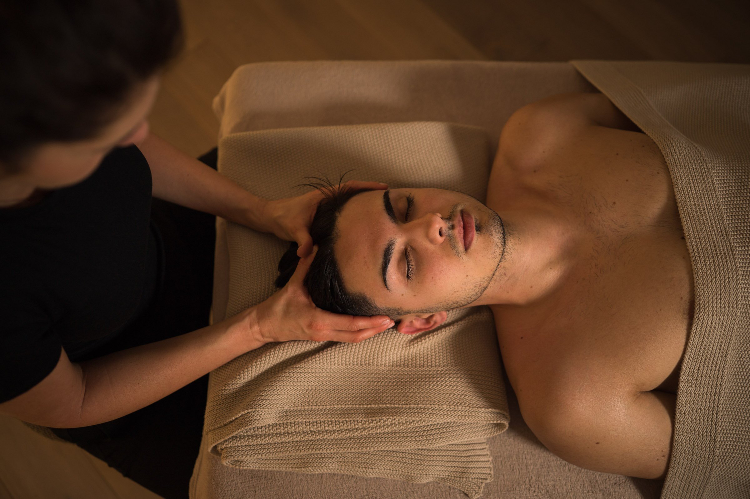 Therapist performing a calming head massage in a peaceful Queen's Park, London studio
