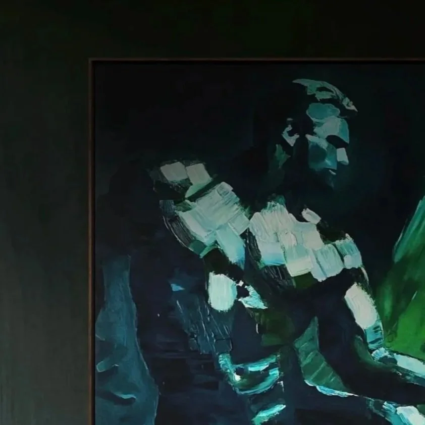 Tiago Caria, Almost Touch (after Michelangelo), 2024, oil on canvas, framed contemporary figurative painting installed in a dark green interior, luminous figure contrasted against shadowed wall, restrained emotional presence.