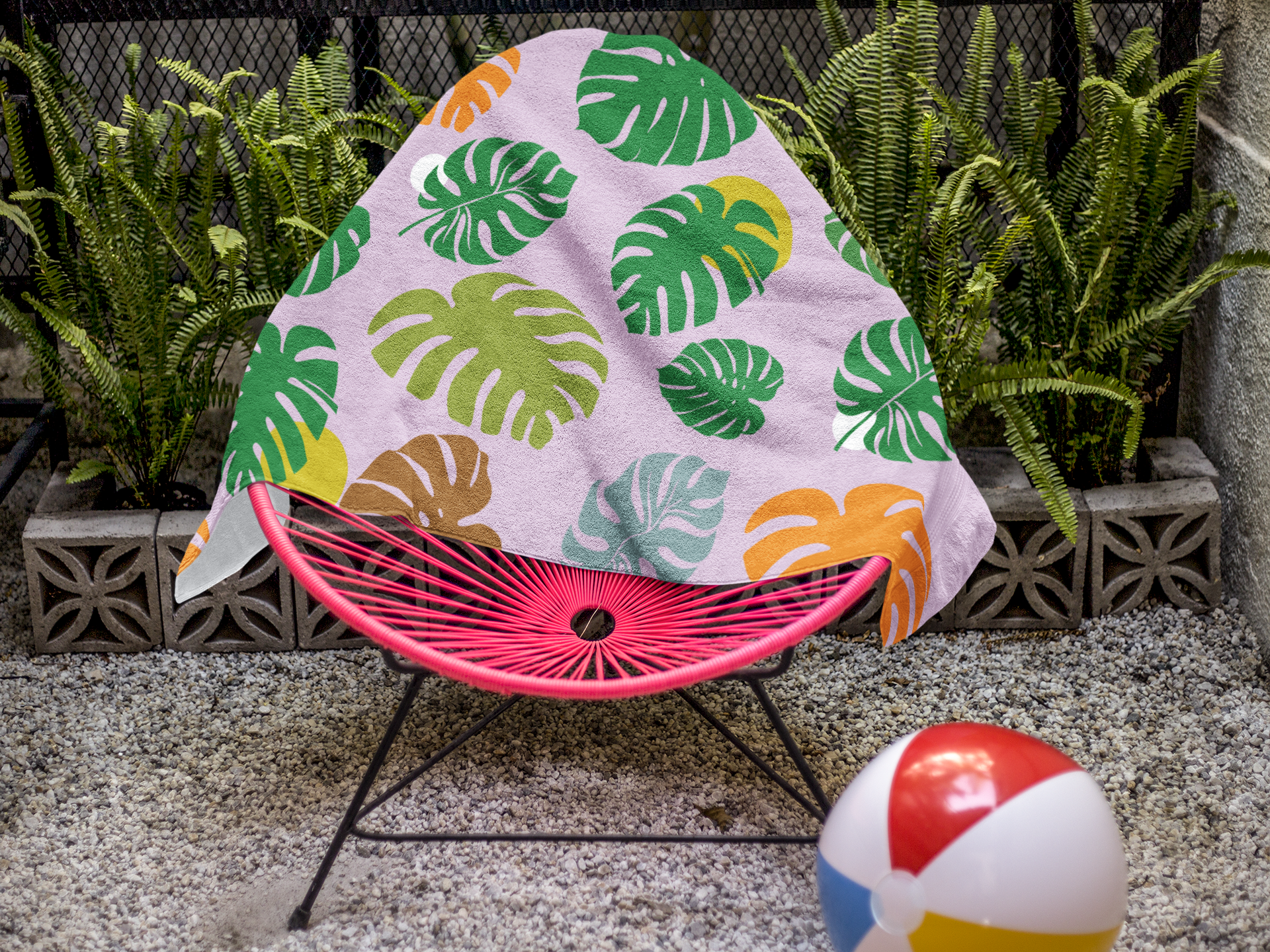 beach-towel-template-on-a-pink-acapulco-chair-near-plants-a14897.png