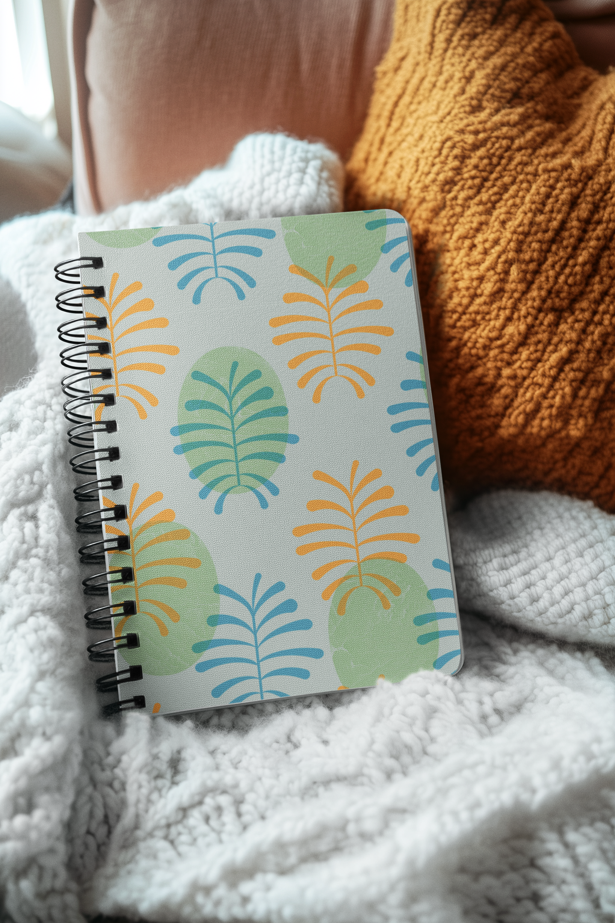 mockup-of-an-ai-generated-spiral-journal-placed-on-a-cozy-and-warm-setting-m53832.png