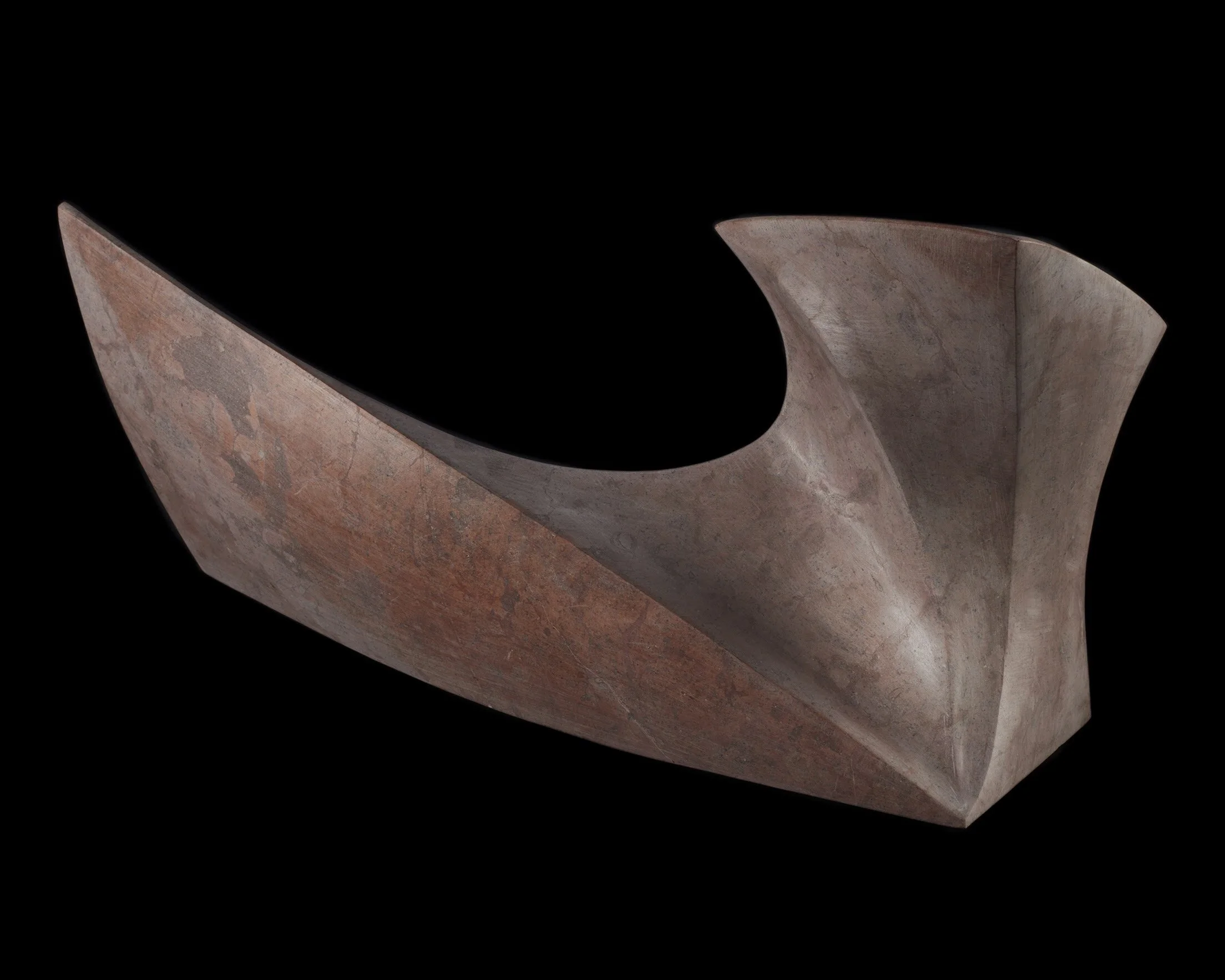 A modern, abstract sculpture with smooth, curved shapes, made of reddish-brown material, set against a black background.