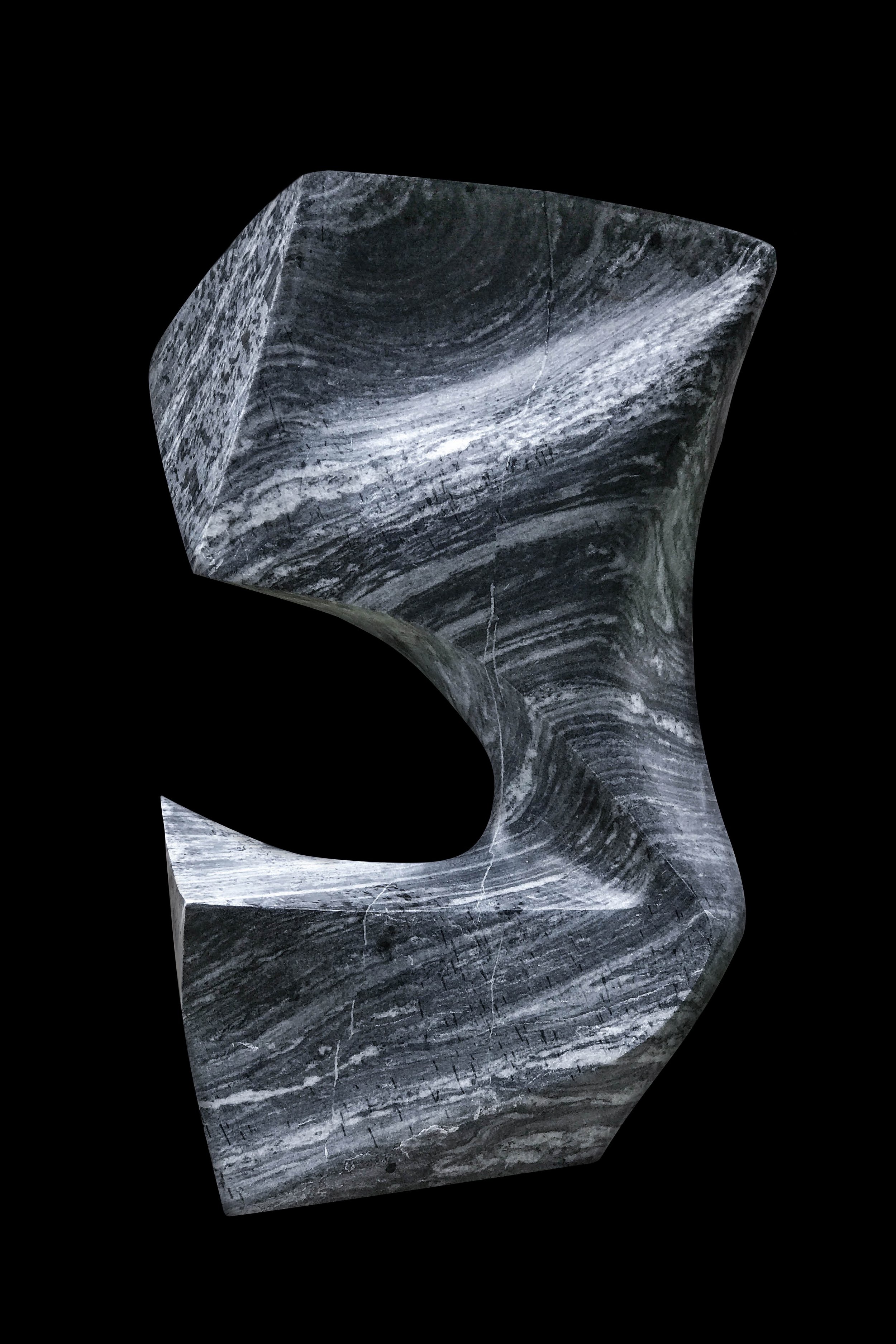 A marble sculpture shaped like a stylized letter 'S' with black, white, and gray swirling patterns, set against a black background.