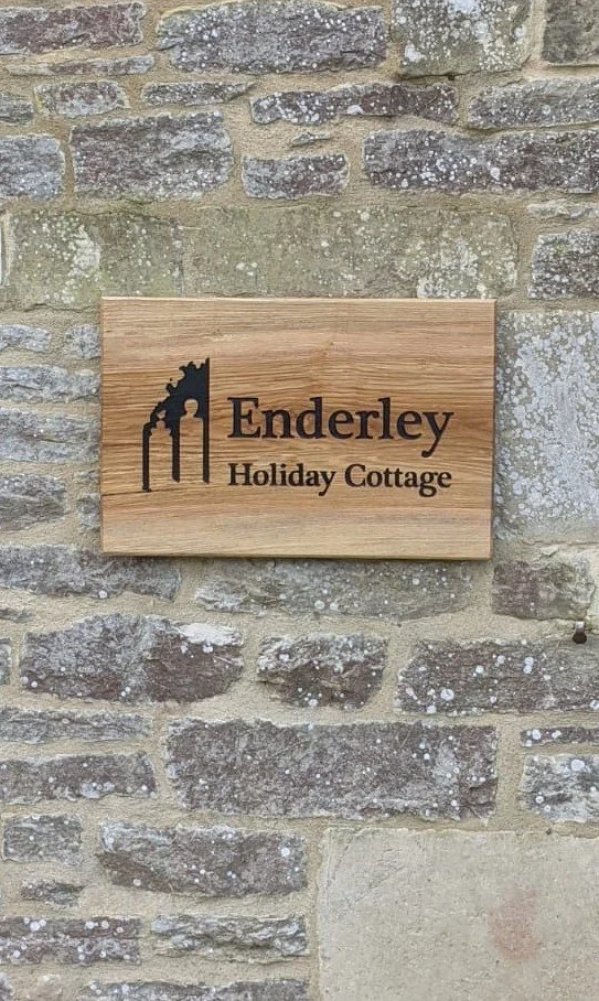 Custom signage with painted infill on behalf of Cedar, Cutts Moore Ltd for Enderley Holiday Cottage