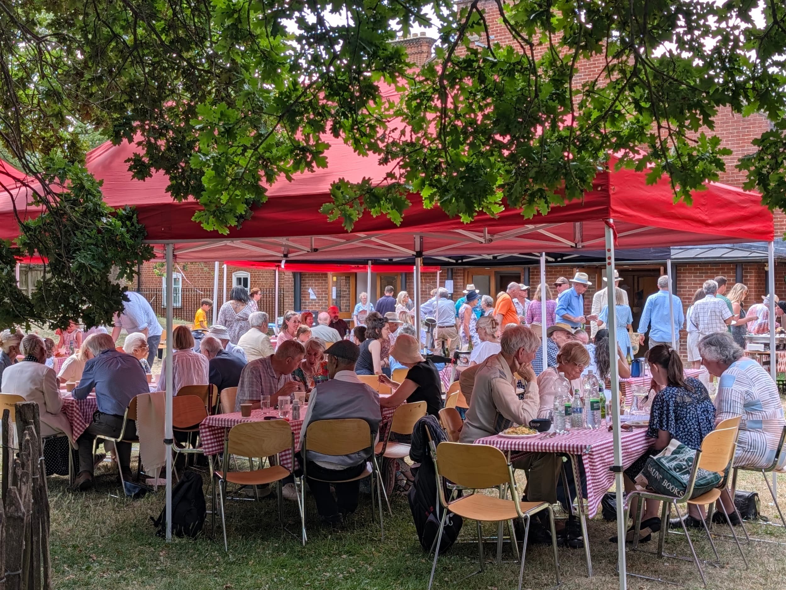 People sat under gazebos enjoying lunch