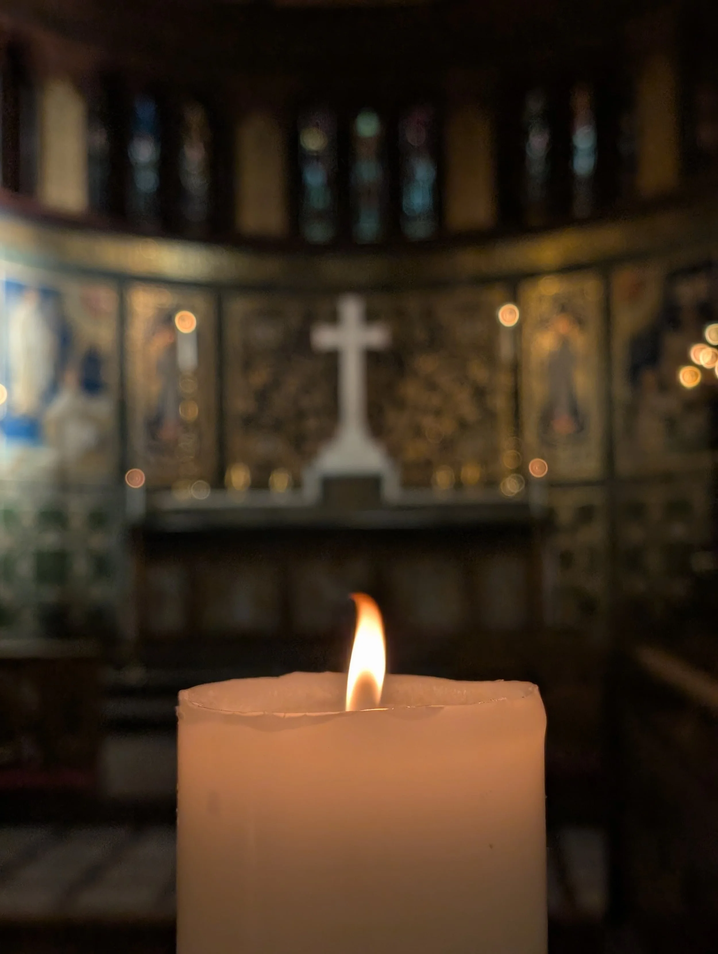 a single candle alight in front of the altar