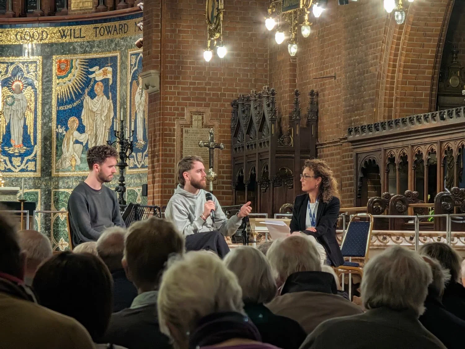 People talking on a stage in church