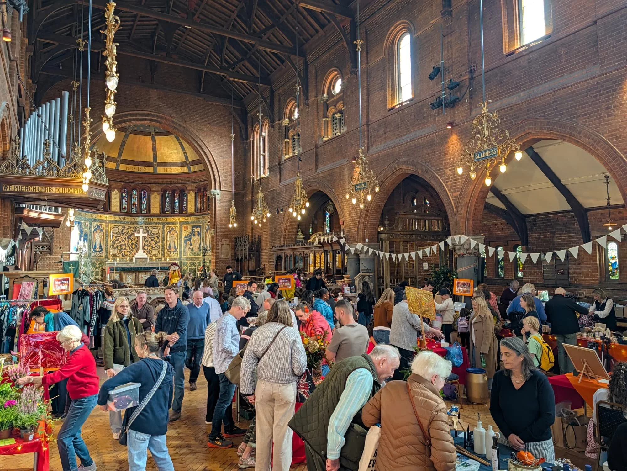 people gathering around market stalls in church
