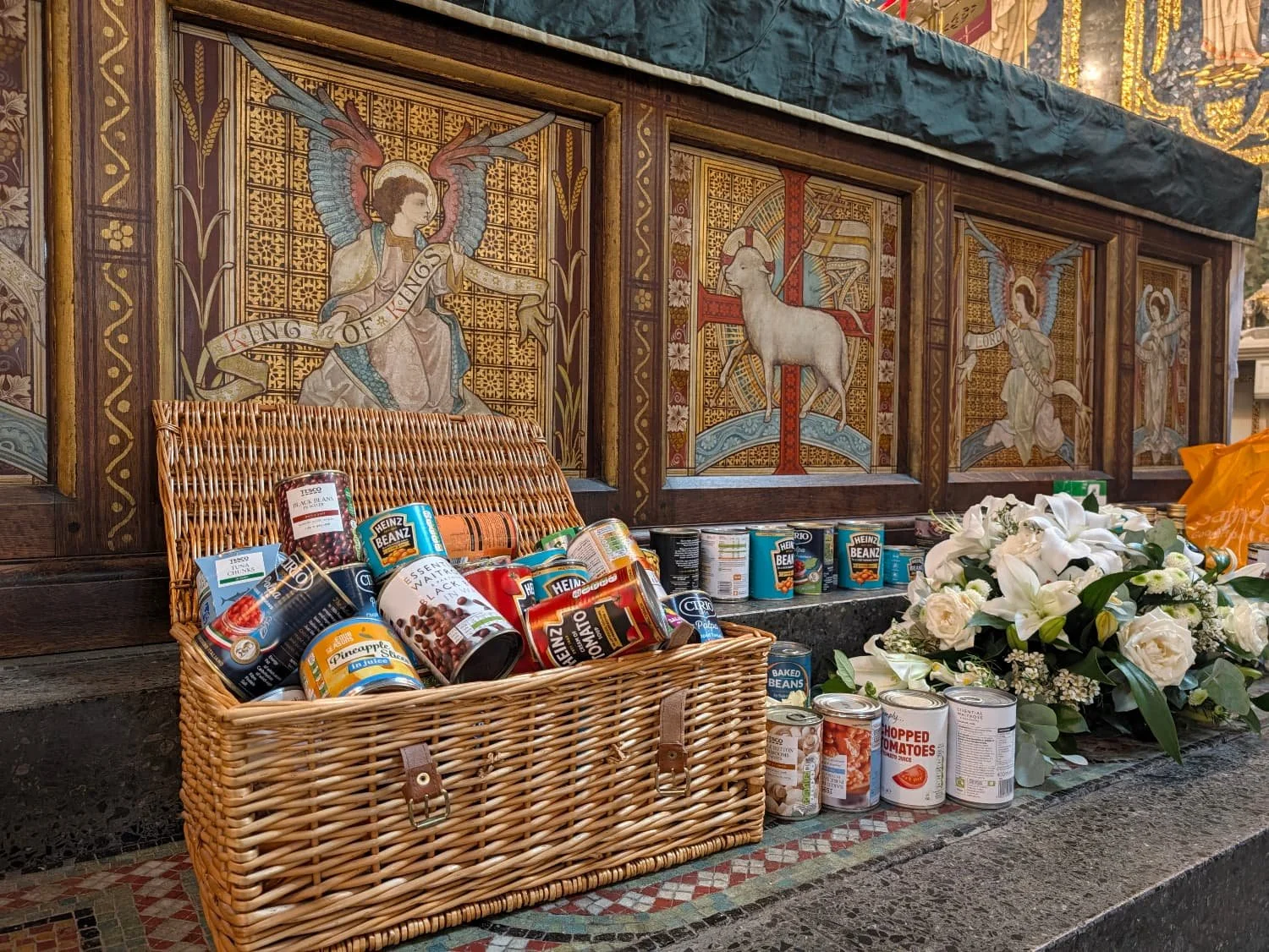 Packets and tins of food placed beneath the altar. 