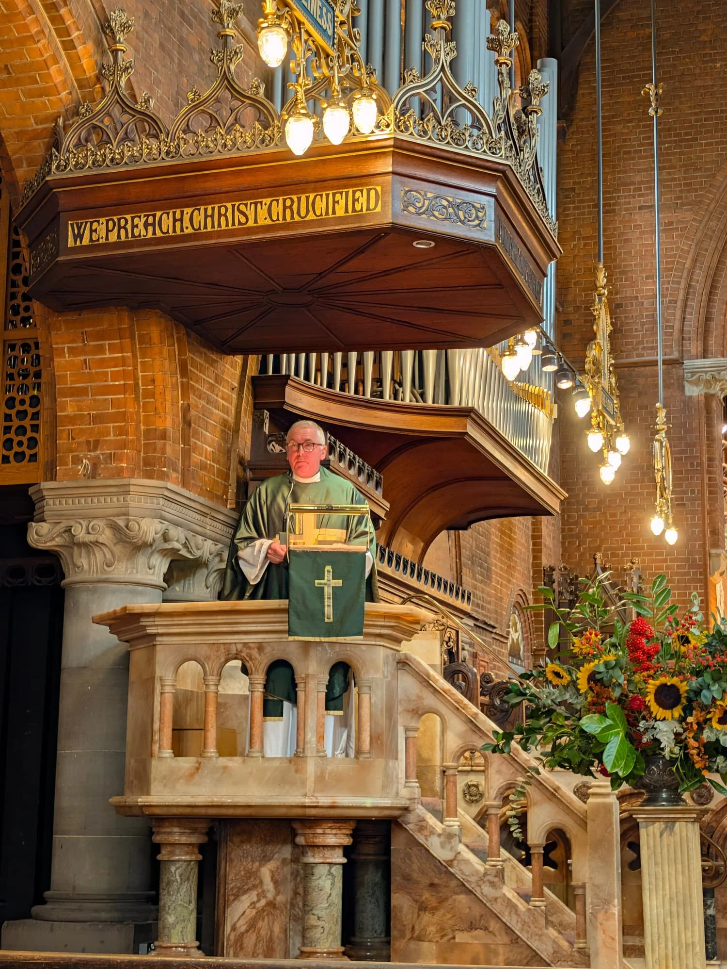 The associate priest preaching from the pulpet