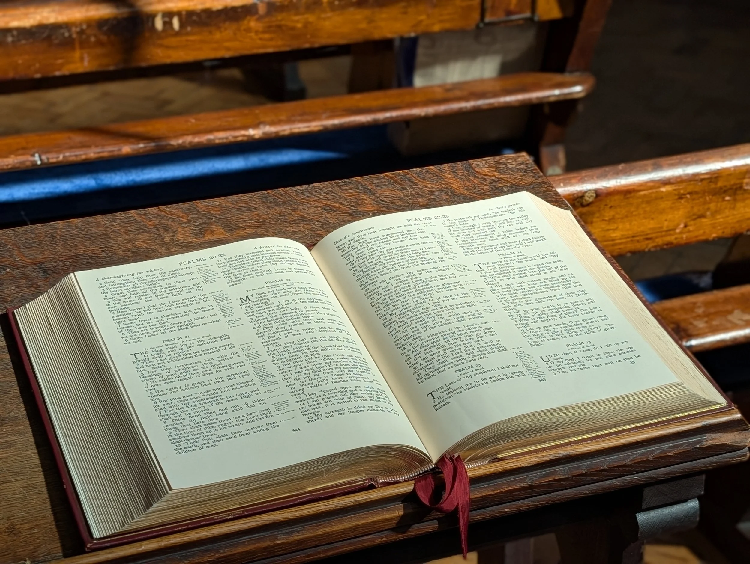 An open Bible on a wooden table