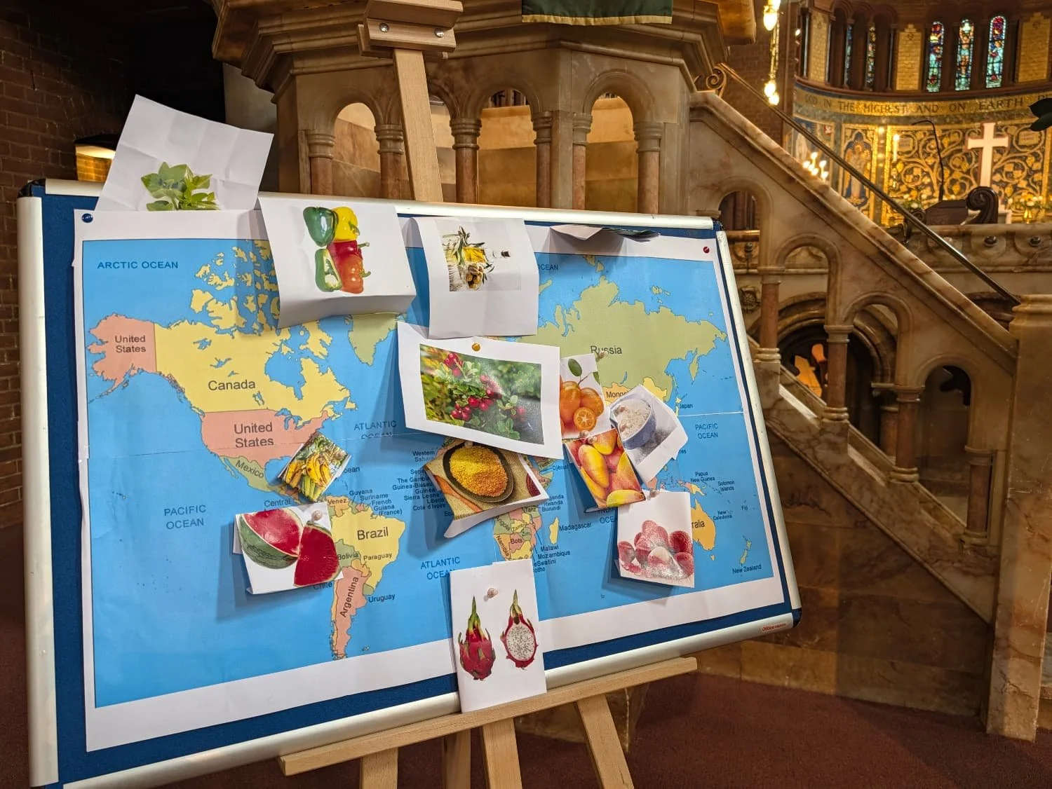 a maps of the world with images of food pinned to it