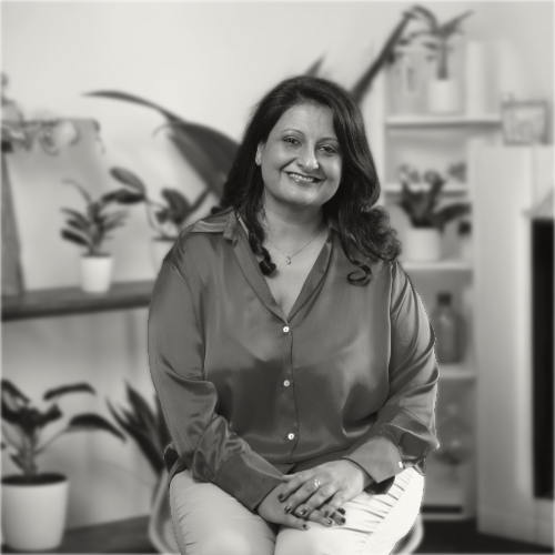 Aru Daswani, ICF PCC executive leadership coach, smiling in her coaching space in Barcelona