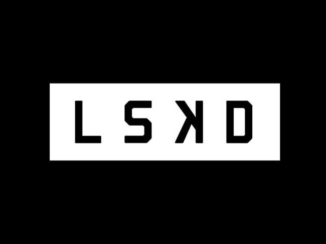 The word 'KIDS' written in black letters upside down on a white background, with black space around it.