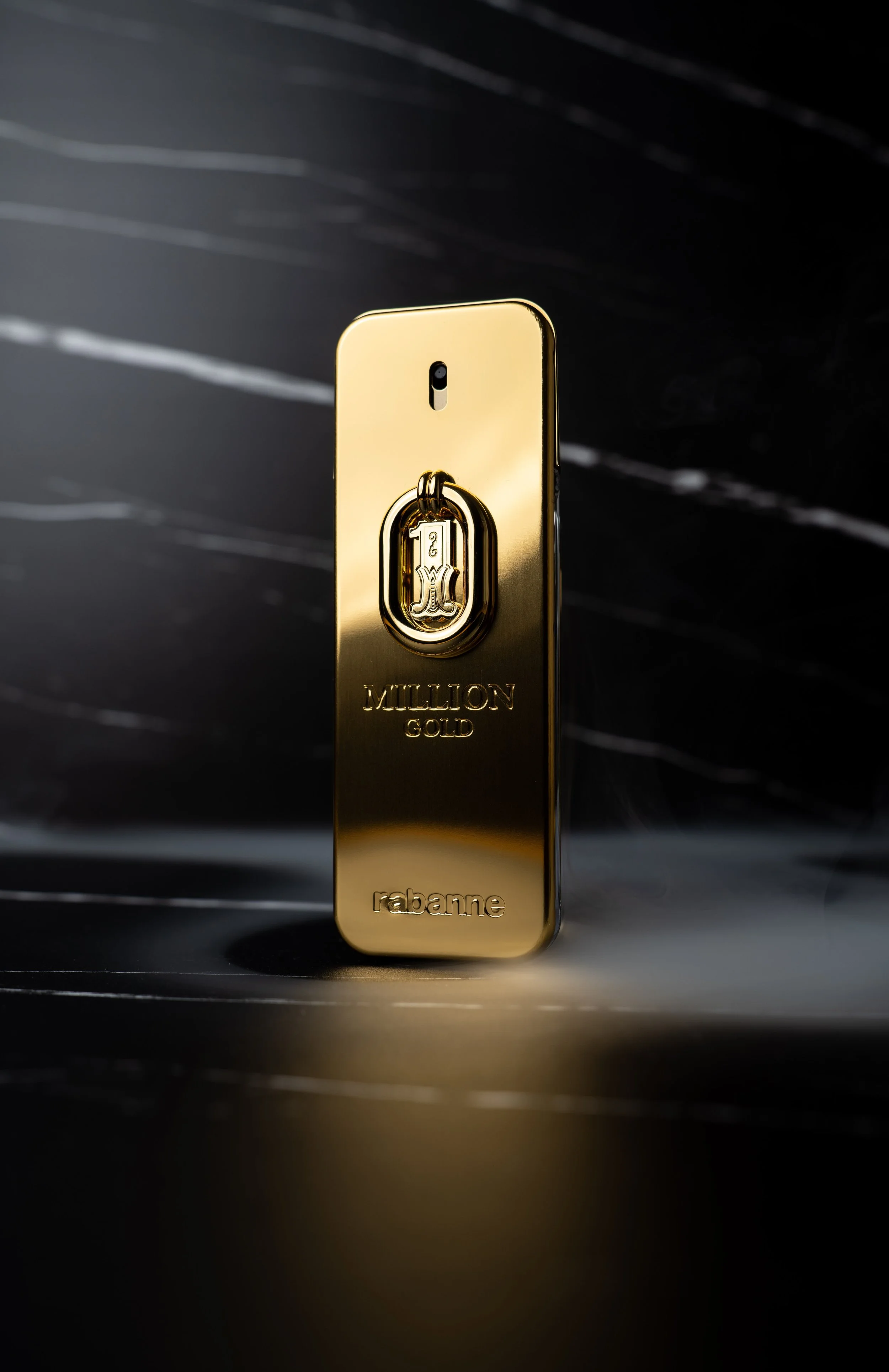 A gold bar with the words 'Million Gold', 'rabanne', and a logo with the number 1 engraved on it.