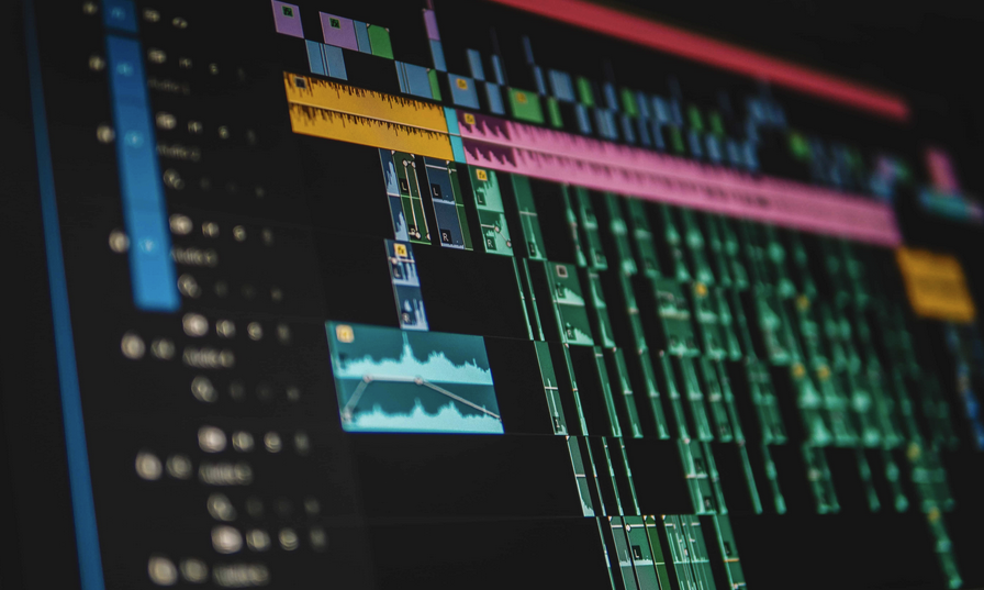 Screenshot of a digital audio editing software with multiple colorful tracks, waveforms, and timeline markers.