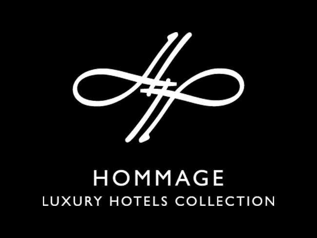 Logo with intertwined lines above the words 'HOMMAGE' and 'LUXURY HOTELS COLLECTION' in white on a black background.
