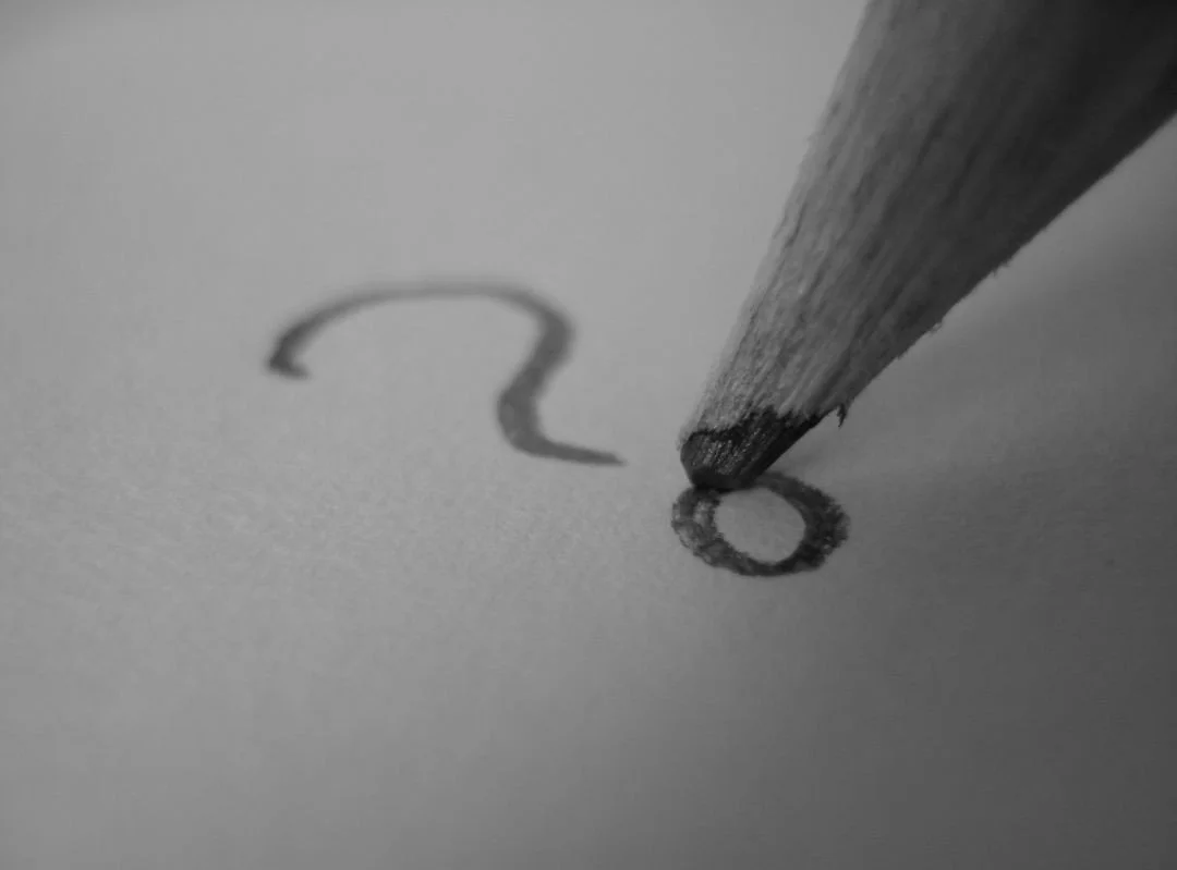Close-up of a pencil drawing a question mark on paper. Ask a question to Mr Ehab Kelada
